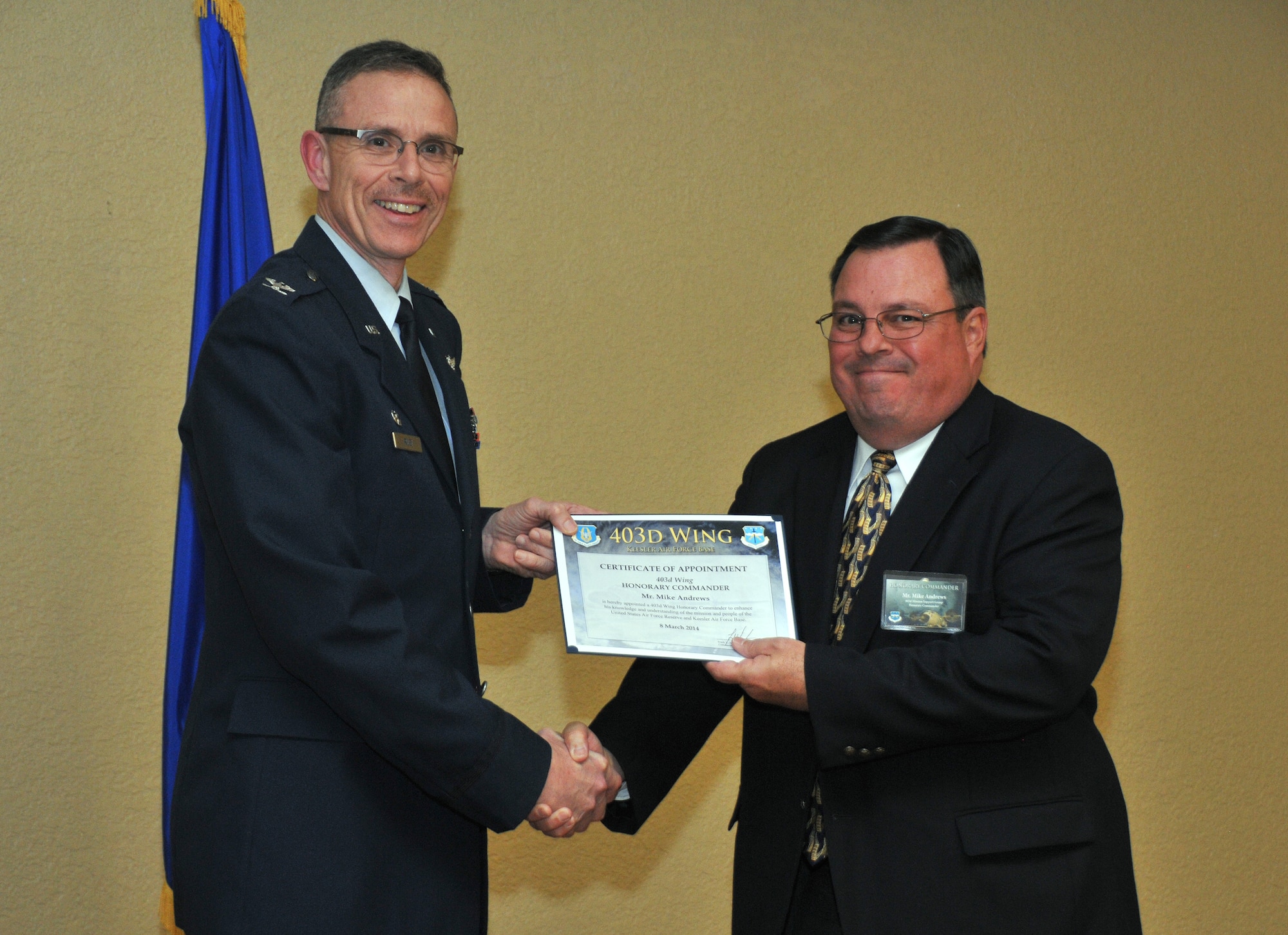 Col. Kevin C. Riley, 403rd Mission Support Group commander, inducts Mike Andrews, Safety and Environment Officer, Harrison County, into the 403rd Wing Honorary Commander Program March 8, 2014.The program provides Gulf Coast community and corporate leaders the chance to learn more about Air Force personnel, programs and operations, but also affords military commanders and members an opportunity to learn more about the people and the inner workings of their local community. (U.S. Air Force photo/Tech. Sgt. Ryan Labadens)