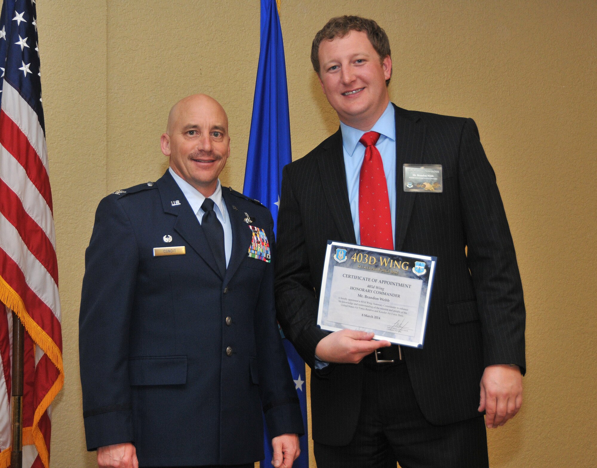Col. David J. Condit, 403d Operations Group commander, inducts Brandon Webb, assistant vice president, Specialized Lending, Bancorp South, into the 403rd Wing Honorary Commander Program March 8, 2014.The program provides Gulf Coast community and corporate leaders the chance to learn more about Air Force personnel, programs and operations, but also affords military commanders and members an opportunity to learn more about the people and the inner workings of their local community. (U.S. Air Force photo/Tech. Sgt. Ryan Labadens)