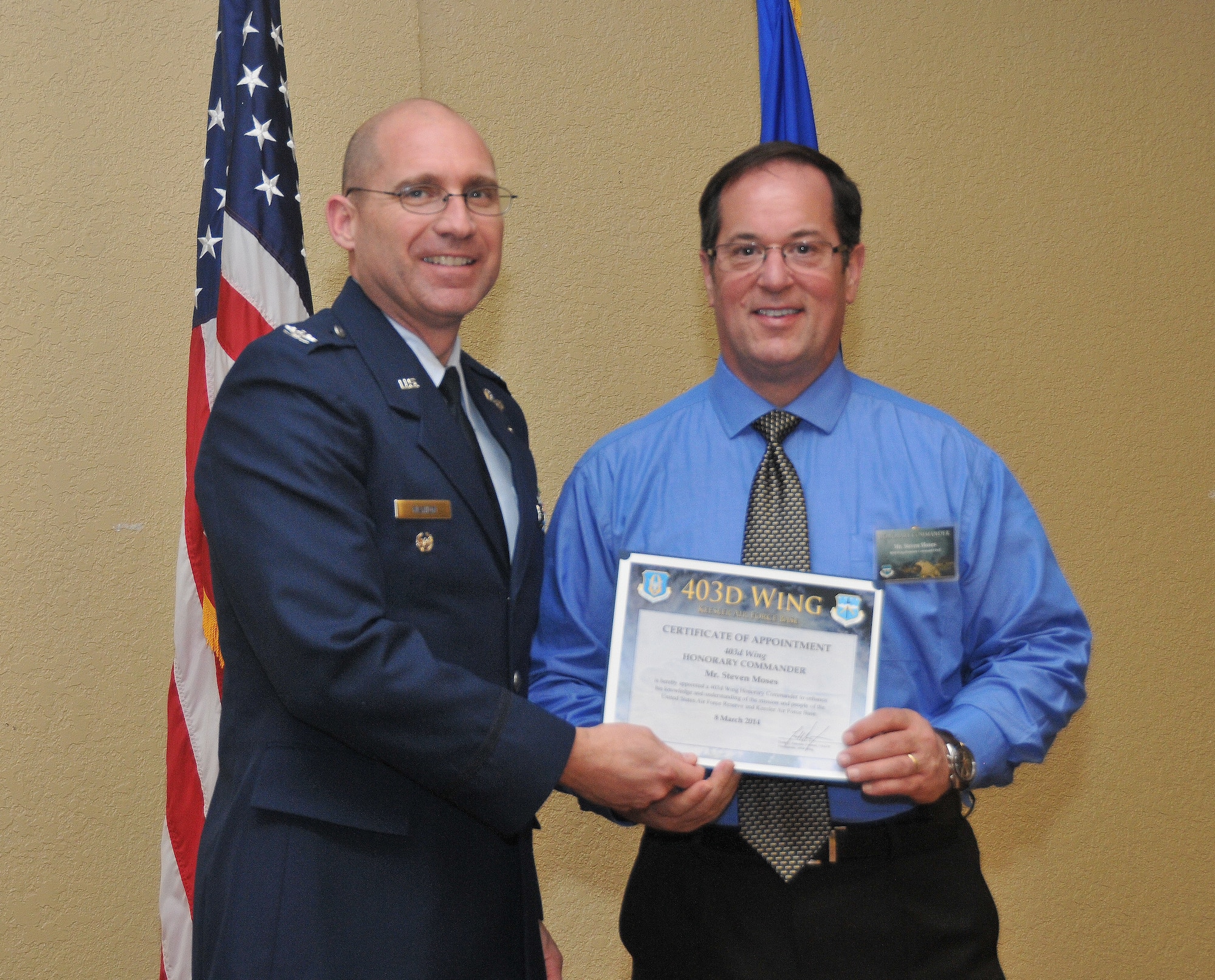 Col. Michael W. Manion, 403rd Wing vice commander, inducts Steven Moses, general manager, Best Buy, into the Honorary Commander Program March 8, 2014.The program provides Gulf Coast community and corporate leaders the chance to learn more about Air Force personnel, programs and operations, but also affords military commanders and members an opportunity to learn more about the people and the inner workings of their local community. (U.S. Air Force photo/Tech. Sgt. Ryan Labadens)