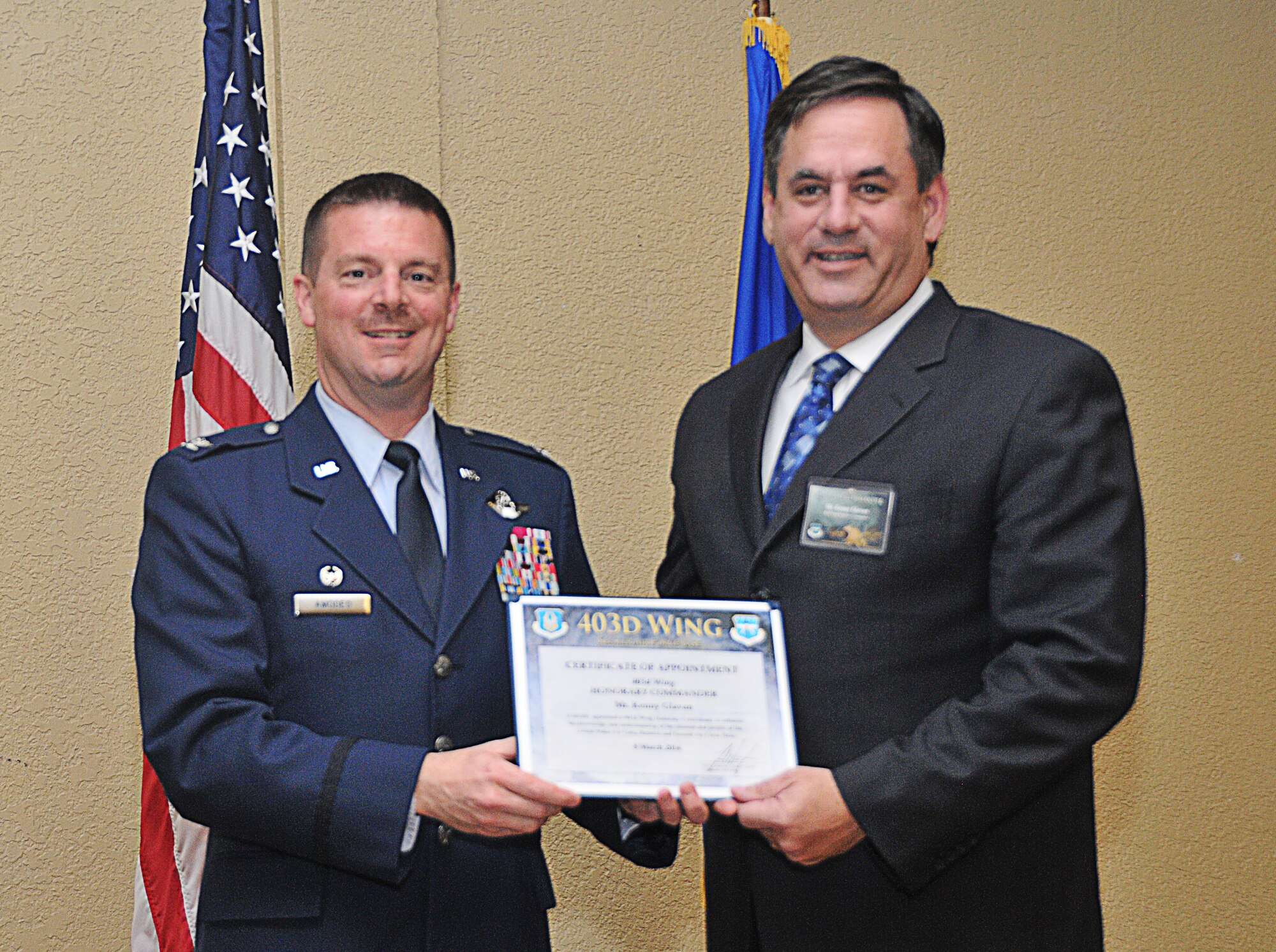Col. Frank L. Amodeo, 403rd Wing commander, inducts Kenny Glavan, Biloxi City Councilman and general manager, Sheraton Four Points, into the Honorary Commander Program March 8, 2014.The program provides Gulf Coast community and corporate leaders the chance to learn more about Air Force personnel, programs and operations, but also affords military commanders and members an opportunity to learn more about the people and the inner workings of their local community. (U.S. Air Force photo/Tech. Sgt. Ryan Labadens)
