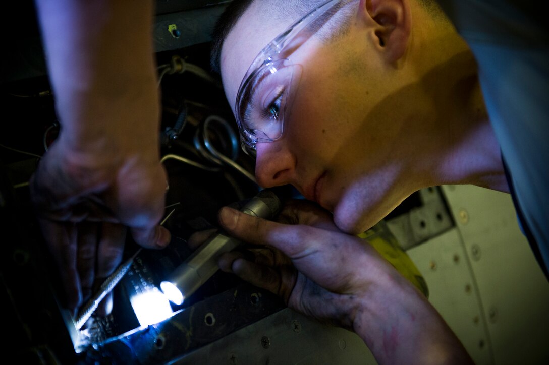 U.S. Air Force Airman 1st Class Phillip Clark of the 158th Fighter Wing replaces the Environmental Control System boot on a F-16 Fighting Falcon on March 8, 2014, at the Vermont Air National Guard base. The ECS boot, attached to the high stage bleed air shut off valve, channels the air off the F-16 engine to provide the cabin with air condition. (U.S. Air National Guard photo by Senior Airman Jon Alderman)
