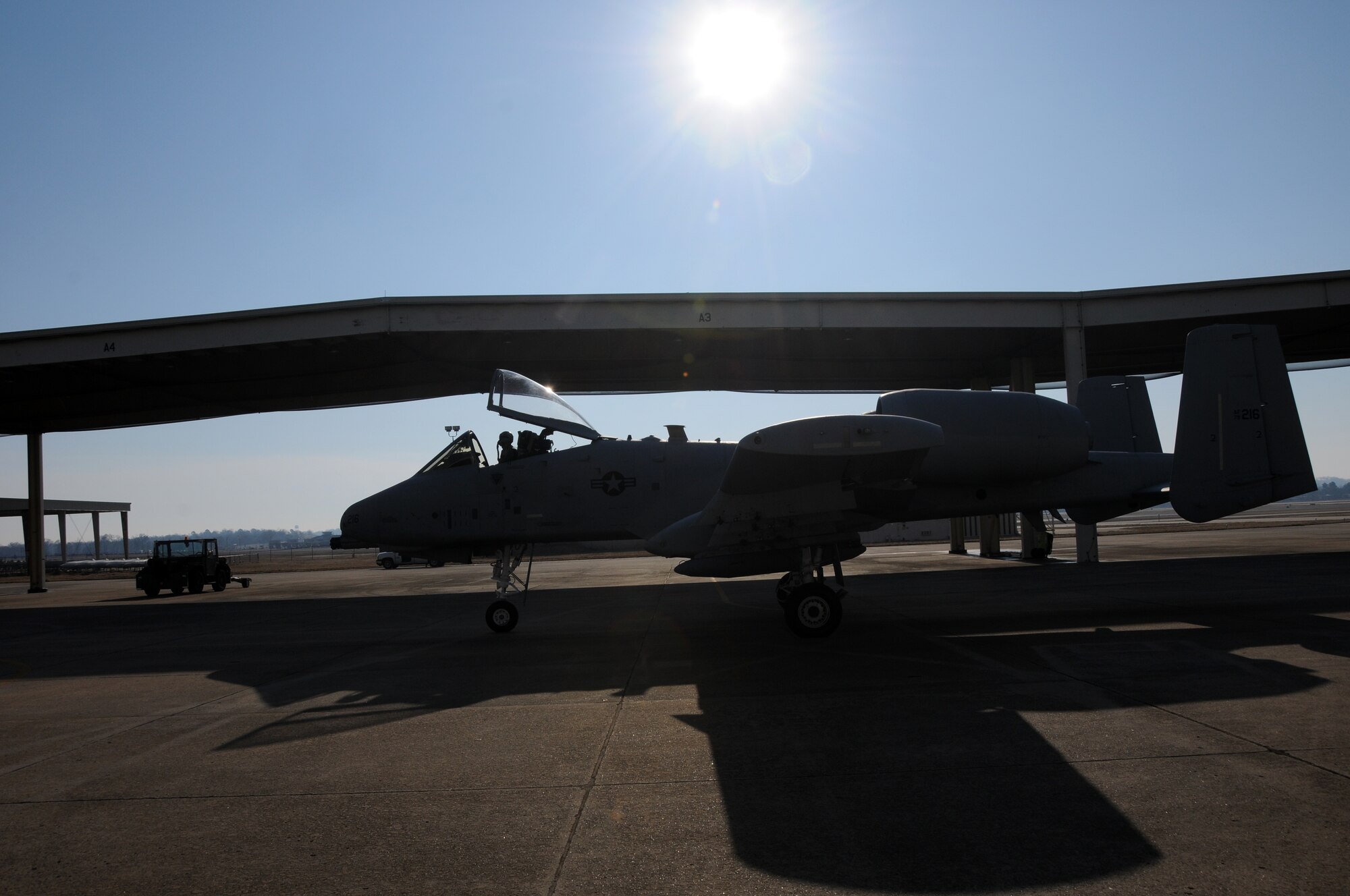 1st Lt. Ellis Moser, a 74th Fighter Squadron pilot, is silhouetted in the morning sun as he taxis to the runway at Ebbing Air National Guard Base, Fort Smith, Ark. March 6, 2014. Moser delivered the A-10C Thunderbolt II “Warthog” (Tail No. 216) to Moody Air Force Base, Ga., as part of the 188th Fighter Wing’s conversion from the A-10 to a remotely piloted aircraft, intelligence and targeting mission. The 188th has six remaining A-10s on station. (U.S. Air National Guard photo by Senior Airman John Hillier/released)