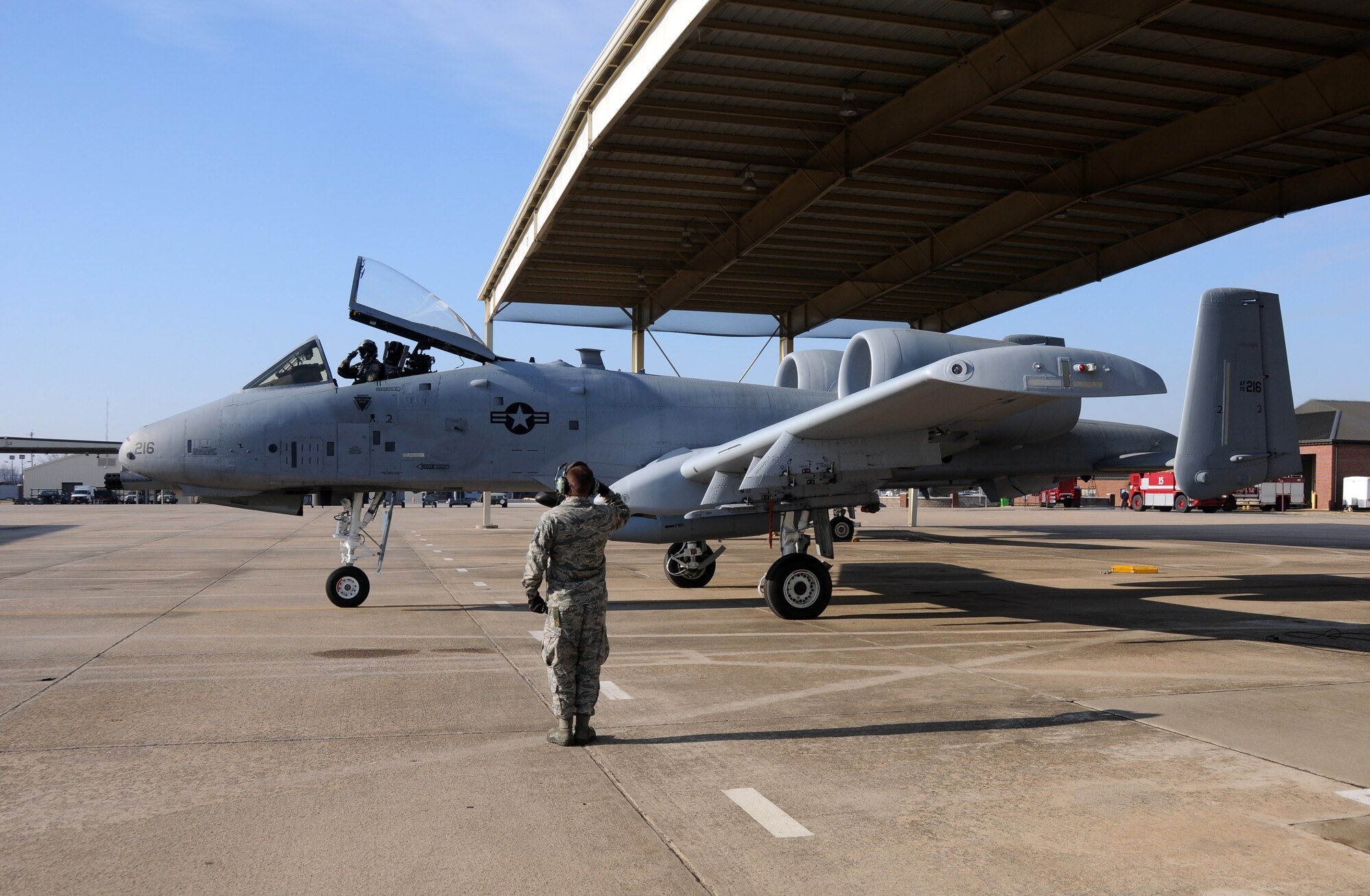 Master Sgt. Tony Crockett of the 188th Aircraft Maintenance Squadron exchanges a salute with 74th Fighter Squadron pilot 1st Lt. Ellis Moser, before takeoff at Ebbing Air National Guard Base, Fort Smith, Ark. March 6, 2014. Moser delivered the A-10C Thunderbolt II “Warthog” (Tail No. 216) to Moody Air Force Base, Ga., as part of the 188th Fighter Wing’s conversion from the A-10 to a remotely piloted aircraft, intelligence and targeting mission. The 188th has six remaining A-10s on station. (U.S. Air National Guard photo by Senior Airman John Hillier/released) 