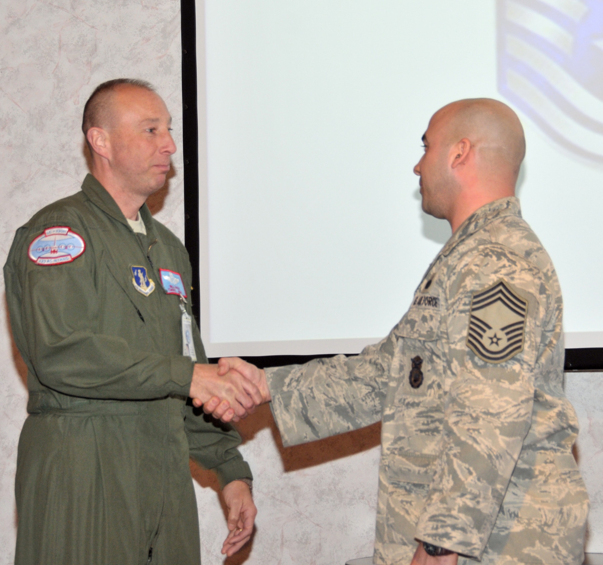 STRATTON AIR NATIONAL GUARD BASE, N.Y. -- Chief Master Sgt. William Nolin (left) welcomes newly promoted Chief Master Sgt. Joshua Walters to the 109th Airlift Wing Chief's Council. Walters, 109th Security Forces Squadron manager, was promoted during a ceremony here March 8, 2014. (Air National Guard photo by Tech. Sgt. Catharine Schmidt/Released)