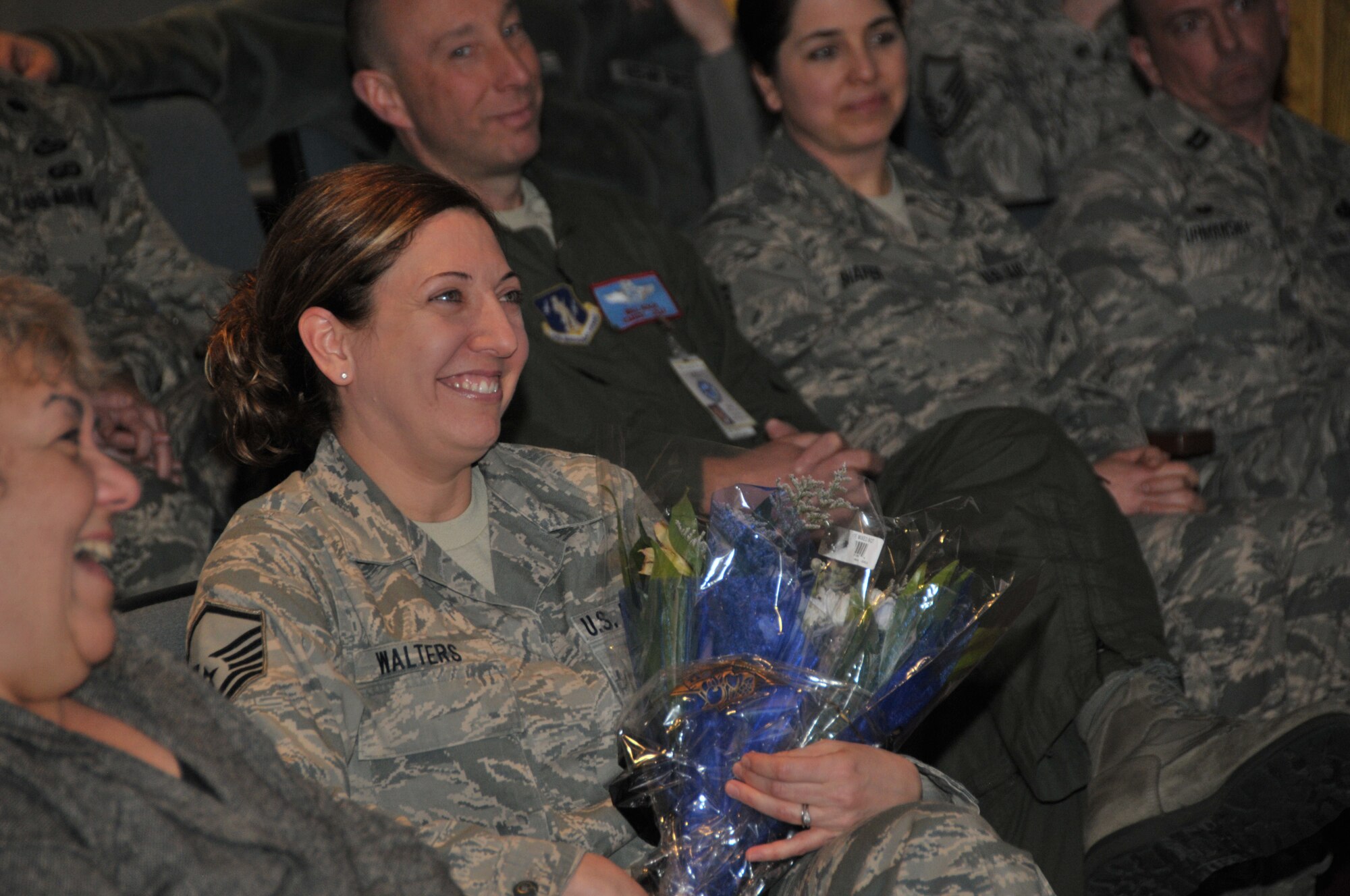 STRATTON AIR NATIONAL GUARD BASE, N.Y. -- Master Sgt. Joanna Walters watches on as her husband, Senior Master Sgt. Joshua Walters, is promoted to chief master sergeant during a ceremony here March 8, 2014. Master Sgt. Walters is the 109th Force Support Squadron's retention office manager, and Chief Walters is the 109th Security Forces Squadron manager. (Air National Guard photo by Tech. Sgt. Catharine Schmidt/Released)