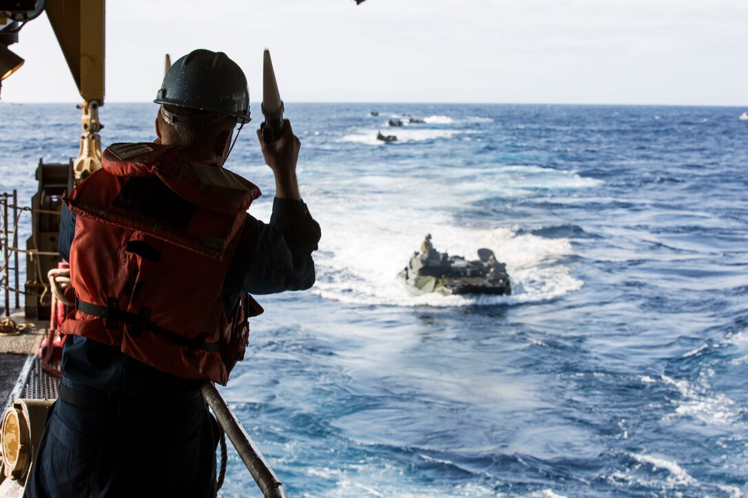 A sailor with the USS Ashland (LSD-48) directs an amphibious assault vehicle into the well deck of the ship during a splash and recovery exercise, Feb. 27. The 31st MEU recently embarked upon the three ships of the USS Bonhomme Richard (LHD-6) Amphibious Ready Group for the regularly-scheduled Spring Patrol. The 31st MEU is the Marine Corps’ force of choice for the Asia-Pacific region and is the only continuously forward-deployed MEU.