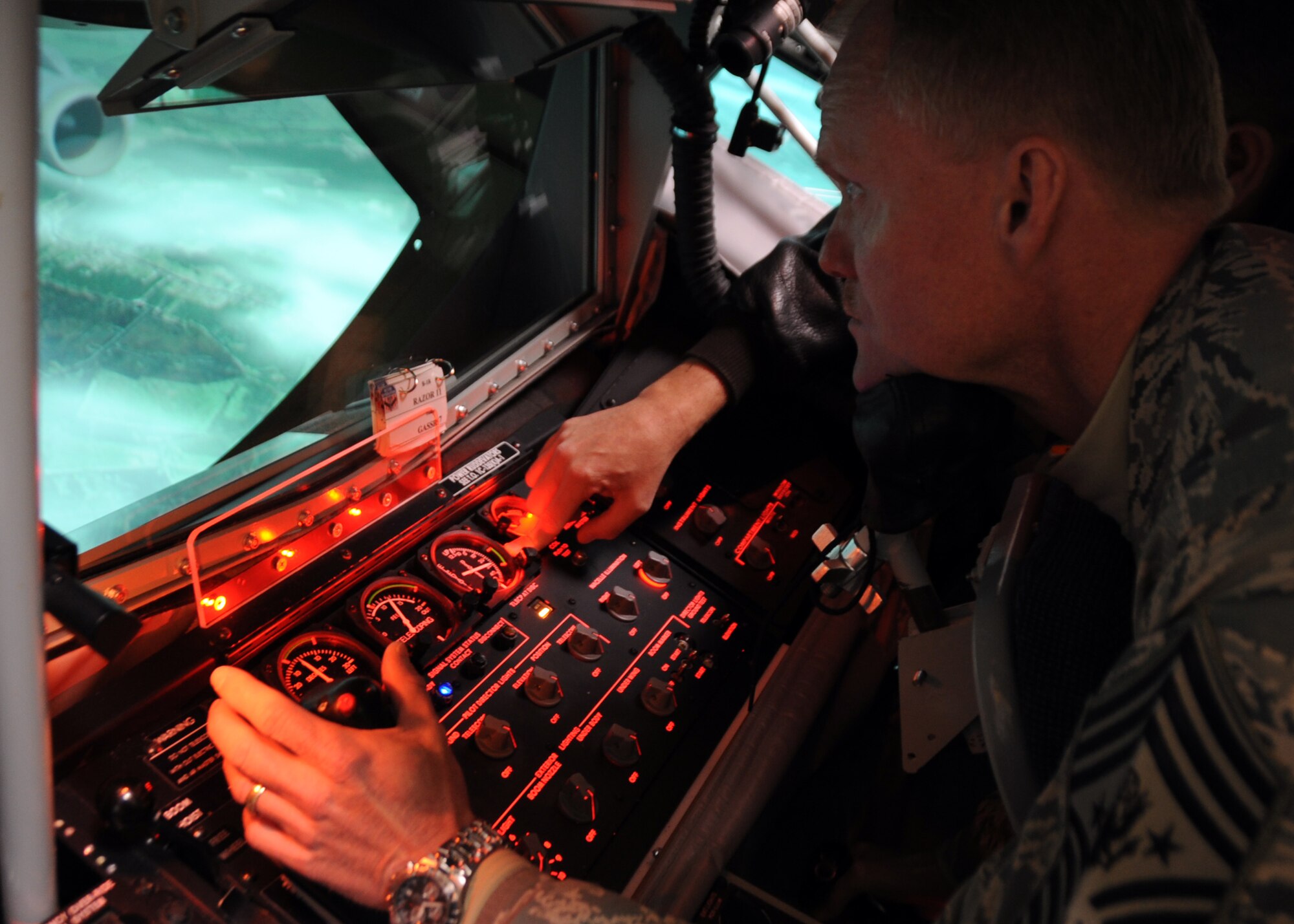 Chief Master Sgt. of the Air Force James A. Cody operates a KC-135 Stratotanker boom operator weapon system trainer at the KC-135 Aircrew Training Center March 6, 2014, at Altus Air Force Base. Cody, Air Force Chief of Staff Mark A. Welsh III and their spouses, Athena and Betty, visited the base to interact with Airmen, their families and the Altus AFB community. (U.S. Air Force photo/Senior Airman Franklin R. Ramos)