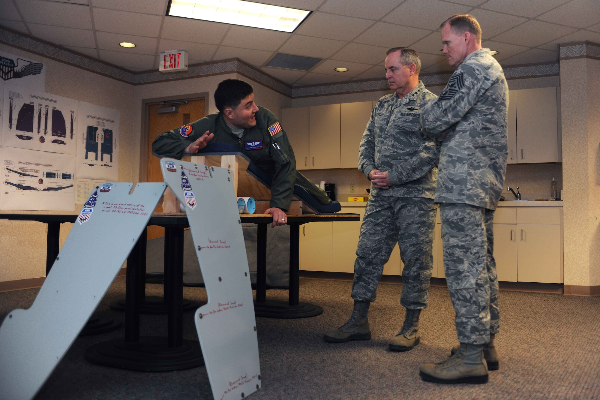 Air Force Chief of Staff Gen. Mark A. Welsh III and Chief Master Sgt. of the Air Force James A. Cody speak with Tech. Sgt. Bartek Bachleda during their March 6, 2014 visit to Altus Air Force Base. Bachleda spoke to Welsh and Cody about the innovative enhancements he made to the KC-135 Stratotanker boom operators’ refueling pod pads, and how the improvements help during daily operations. Bachleda is a 54th Air Refueling Squadron instructor. (U.S. Air Force photo/Senior Airman Jesse Lopez)