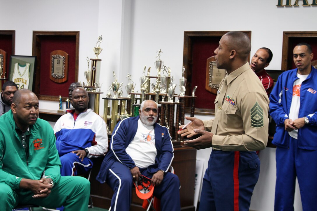 Master Sgt. Mark McArthur, the Marine Corps Recruiting Command Diversity Chief and a Jackson, Miss. native, speaks to the coaches of the men's and women's basketball teams from the 13 colleges and universities of the Mid Eastern Athletic Conference basketball tournament, March 8. McArthur spoke of the importance of Historically Black Colleges and Universities, and how the Marine Corps can work with the coaches and teams to motivate the players, such as the Marine Corps' Combat Fitness Test. The coaches and Marines met before the MEAC Youth Clinic, in which the coaches and Marines worked with nearly 100 young people from the Norfolk area Boys and Girls Clubs, teaching some basic warmup and exercise routines, as well as, basketball fundamentals. The event gave the coaches and Marines an opportunity to make a positive impact on the Norfolk community.
