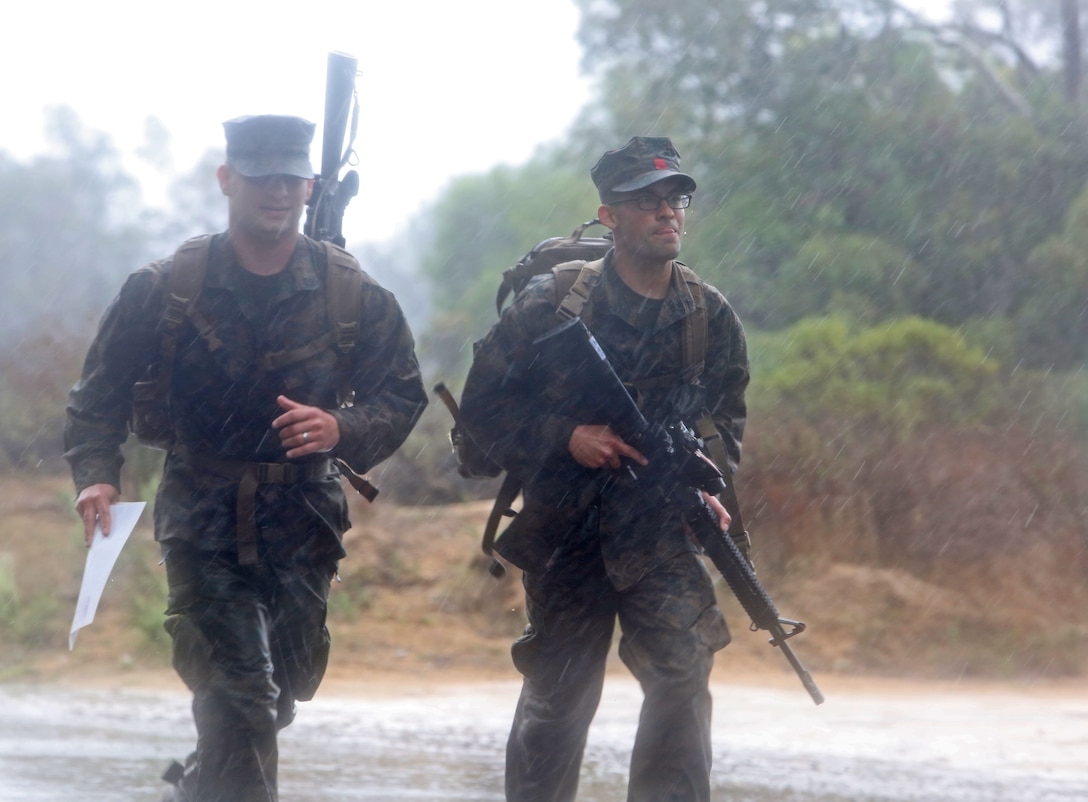 Sergeant Robert Baca (left), 23, communication chief, Landing Support Company, Combat Logistics Regiment 17, 1st Marine Logistics Group, and Lance Cpl. Anthony Lucero (right), 20, radio operator, LS Co., CLR-17, 1st MLG, sprint to the finish line during the final moments of a land navigation course aboard Camp Pendleton, Calif. Feb. 28, 2014. Land nav. is an invaluable skill set and forms one of the core competencies of a leader. The purpose of the course is to establish individual confidence and proficiency in tasks associated with land nav. Each Marine was issued a compass, protractor and map. To complete the course, they had to locate six points within six hours.