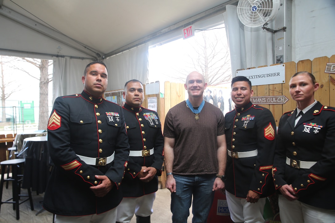 The Marine Corps Mounted Color Guard, stationed on Marine Corps Logistics Base Barstow, Calif., poses for a picture with Army Staff Sgt. Ty Carter, cavalry scout, grand marshal of the Downtown Rodeo Parade in Houston, and Medal of Honor recipient, at the Houston Livestock Show and Rodeo, March 1. Carter received his Medal of Honor for his heroic actions as a specialist during the Battle of Kamdesh on his first deployment in Afghanistan.