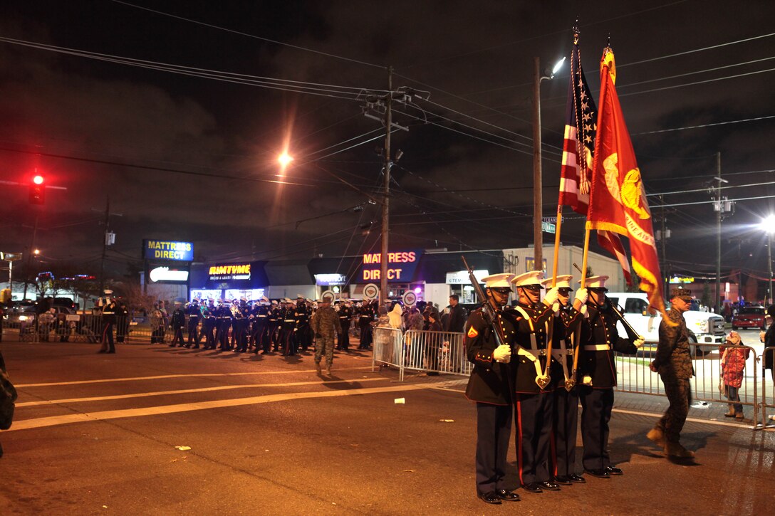 METAIRIE, La. The 2nd Marine Aircraft Wing color guard marches in front of the 2nd MAW band from Marine Corps Air Station Cherry Point, N.C., in the Krewe of Zeus Mardi Gras parade in Metairie, La., March 3, 2014. A United States Marine Corps color guard is comprised of four Marines: the Color Sergeant, the Marine Corps Color Bearer, and the Left and Right Riflemen.  The 2nd MAW band and color guard traveled to New Orleans specifically to support the high-performance demand of Mardi Gras. (U.S. Marine Corps Photo by Cpl. J. Gage Karwick/Released)