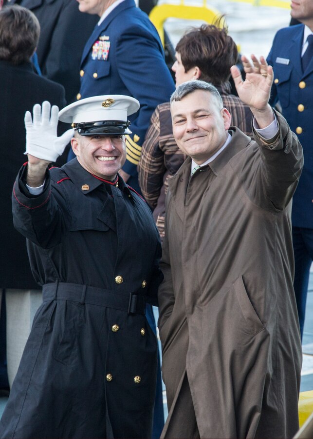 Sgt. Maj. Anthony Spadaro, (Left) sergeant major of Marine Forces Reserve and Marine Forces North, and Gregg Habel, executive director of MARFORRES and MARFORNORTH, wave to the crowd aboard the U.S. Coast Guard Cutter Harry Claiborne during the Lundi Gras festival in New Orleans, March 3, 2014. The cutter carried the Zulu King and Queen of the procession, delivering them to their parade route and the awaiting crowd. (U.S. Marine Corps photo by Lance Cpl. Mackenzie Schlueter/Released)