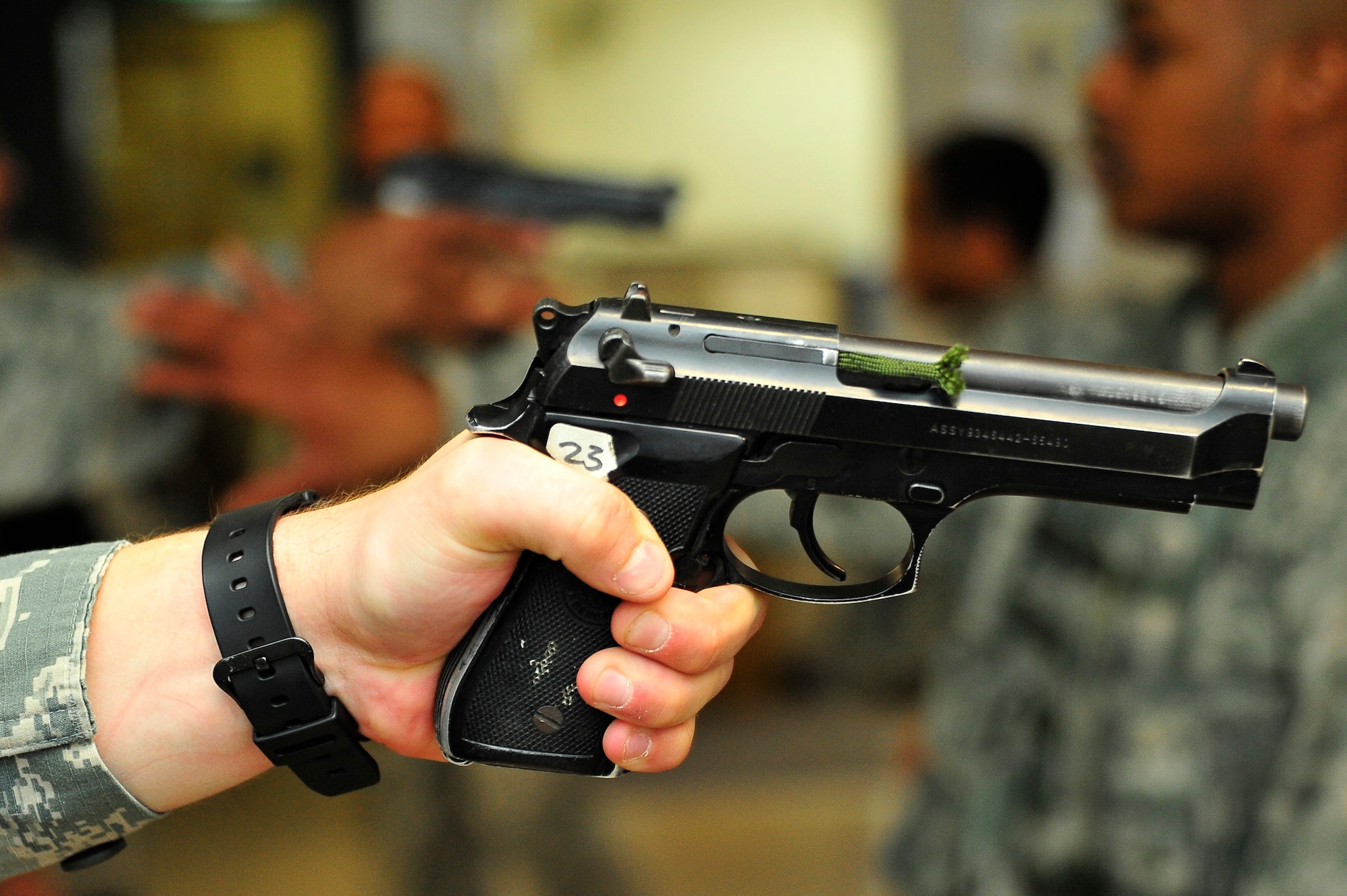 A U.S. Air Force Airman holds out an M-9 pistol during a training drill as part of a Pacific Air Forces High Risk Response course at Misawa Air Base, Japan, March 6, 2014. The purpose of the training drill was to disarm a threat at close range. (U.S. Air Force photo/Staff Sgt. Nathan Lipscomb)