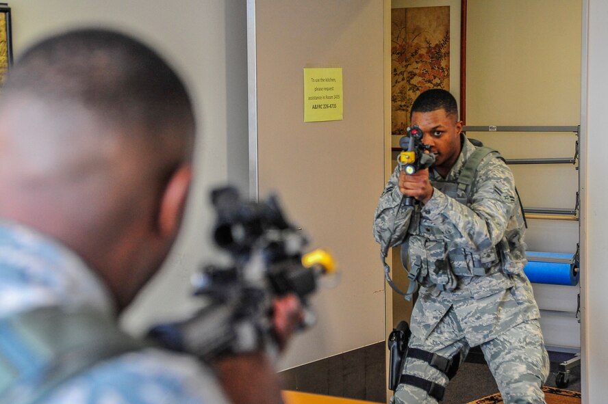 U.S. Air Force Airman 1st Class Travion Fortune, 35th Security Forces Squadron member, targets an active-shooter as part of student-led scenarios during a Pacific Air Forces High Risk Response course at Misawa Air Base, Japan, March 6, 2014. On the fourth day of the course, personnel from the 35 SFS practiced training each other on these new tactics, techniques and procedures. (U.S. Air Force photo/Staff Sgt. Nathan Lipscomb) 
