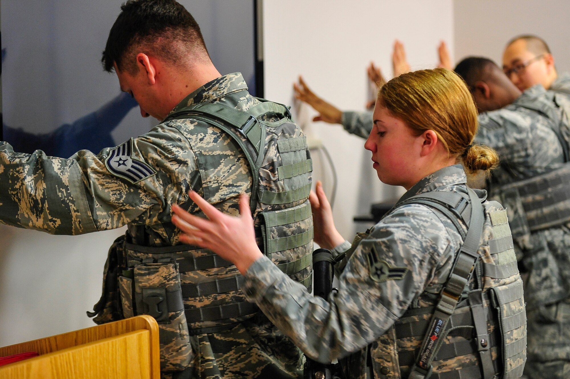 U.S. Air Force Airman 1st Class Miranda Lauriello pats down fellow 35th Security Forces Squadron member Staff Sgt. Matthew Schreiner during a Pacific Air Forces High Risk Response course at Misawa Air Base, Japan, March 6, 2014. The five day training course used interactive academics, exercise, newly developed tactics and techniques grounded in contemporary Special Weapons and Tactics training. (U.S. Air Force photo/Staff Sgt. Nathan Lipscomb)