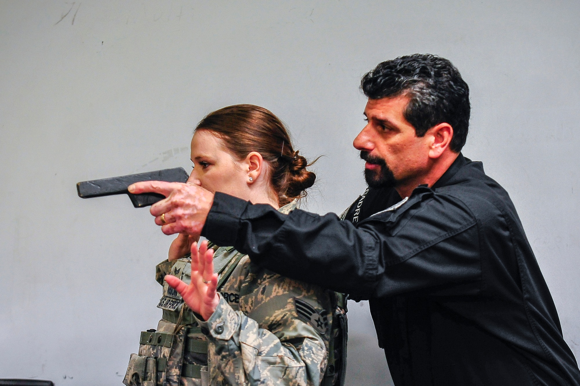John Knipe, Pacific Air Forces High Risk Response Training team leader, simulates holding U.S. Air Force Senior Airman Jaklyn Ivison, 35th Security Forces Squadron member, hostage during a PACAF High Risk Response course at Misawa Air Base, Japan, March 6, 2014. The five-day course is designed to help 35 SFS Airmen prepare to meet dangerous and unpredictable situations on military installation that require immediate law enforcement action.  (U.S. Air Force photo/Staff Sgt. Nathan Lipscomb)