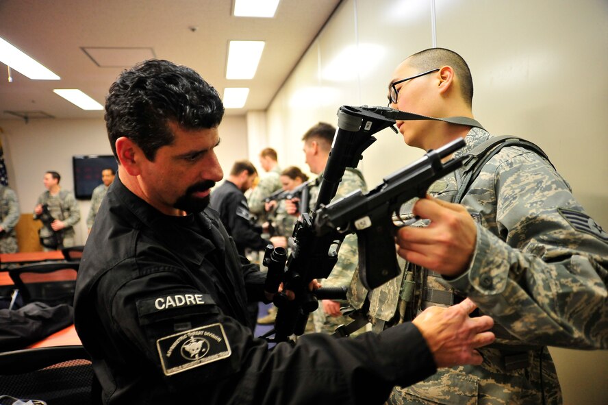 John Knipe, Pacific Air Forces High Risk Response Training team leader, checks U.S. Air Force Staff Sgt. Richard Kang, 35th Security Forces Squadron member, and his weapons for any live ammunition before starting a PACAF High Risk Response course at Misawa Air Base, Japan, March 6, 2014. The training taught 35 SFS Airmen how to safely and effectively respond to, confront and stop an active shooter. (U.S. Air Force photo/Staff Sgt. Nathan Lipscomb) 