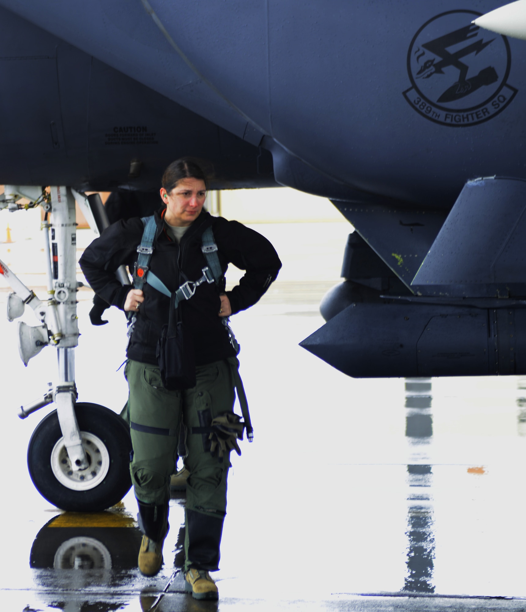 Lt. Col. Shelly Mendieta, 366th Fighter Wing chief of Wing safety, disembarks from an F-15E Strike Eagle March 10, 2014, at Mountain Home Air Force Base, Idaho. The combat exercise Gunfighter Flag is designed to prepare multiple joint and coalition terminal attack controller teams for upcoming deployments as well as provide proficiency training for aircrews. Despite the wet and soggy conditions, aircrews performed close-air support missions for the JTACs on the ground. (U.S. Air Force photo by Senior Airman Ben Sutton/Released)