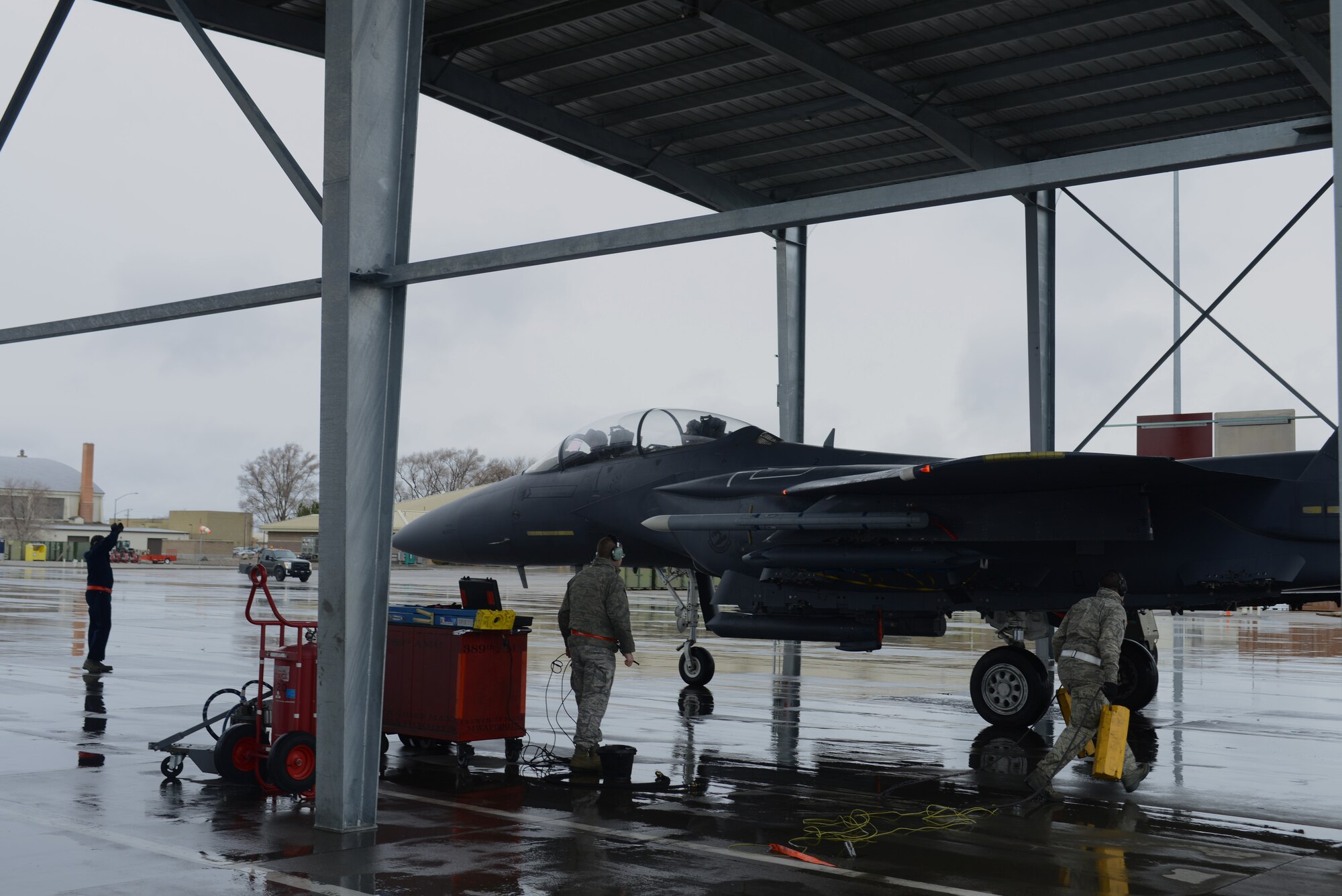 From left, Staff Sgt. Michael Gates, 366th Aircraft Maintenance Squadron crew chief, Staff Sgt. Timothy Detchon, 366th AMXS avionics specialist, and Senior Airman Ben Failer, 366th AMXS aircraft armament systems technician, recover an F-15E Strike Eagle March 10, 2014, at Mountain Home Air Force Base, Idaho. Operations out of MHAFB will be increased throughout the week of March 10-14 due to the combat exercise Gunighter Flag. Gunfighter Flag is an excellent opportunity to prepare multiple joint and coalition terminal attack controller teams for upcoming deployments as well as provide proficiency training for air and ground crews.
(U.S. Air Force photo by Senior Airman Ben Sutton/Released)