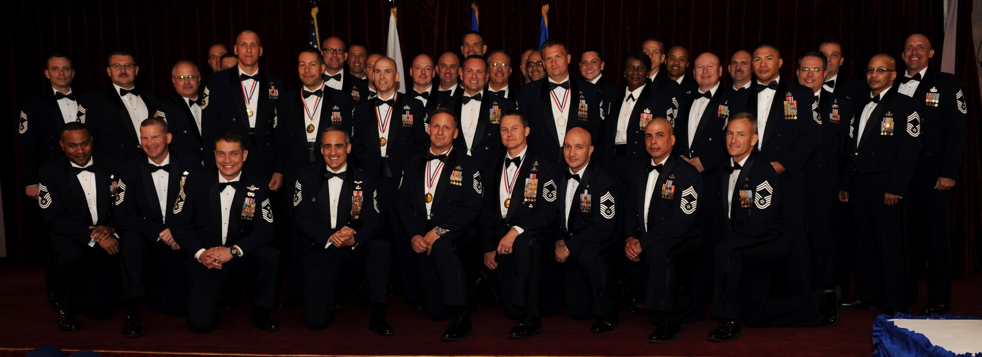 The 18th Wing Chiefs Group poses for a group photo with newly promoted chief master sergeants at the Chief Recognition Ceremony at the Rocker NCO Club on Kadena Air Base, Japan, March 6, 2014. The six Airmen recognized were Chief Master Sgts. Kenneth Carter, 82nd Reconnaissance Squadron, and Robert Chacon, 18th Wing Erwin Professional Military Education Center, as well as Senior Master Sgts. William Horay, 961st Aircraft Maintenance Unit; Robert Miller, 909th Aircraft Maintenance Unit; Daniel Moss, 18th Civil Engineer Squadron; and Michael Stockdale, 320th Special Tactics Squadron. (U.S. Air Force photo by Airman 1st Class Hailey R. Staker)