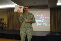 Chap. (Capt.) Christopher Watson, 319th Air Base Wing chaplain, talks to Airmen and family members attending a several marriage-enrichment seminar based on the book entitled, "Love & Respect: The Love She Most Desires, The Respect He Desperately Needs," by Dr. Emerson Eggerichs, Nov. 15, 2013, at the Northern Lights Club on Grand Forks Air Force Base, N.D. The seminar was one of several events offered during the base’s recent Wingman Day, which focused on spiritual and social fitness. (U.S. Air Force photo/Staff Sgt. Luis Loza Gutierrez)