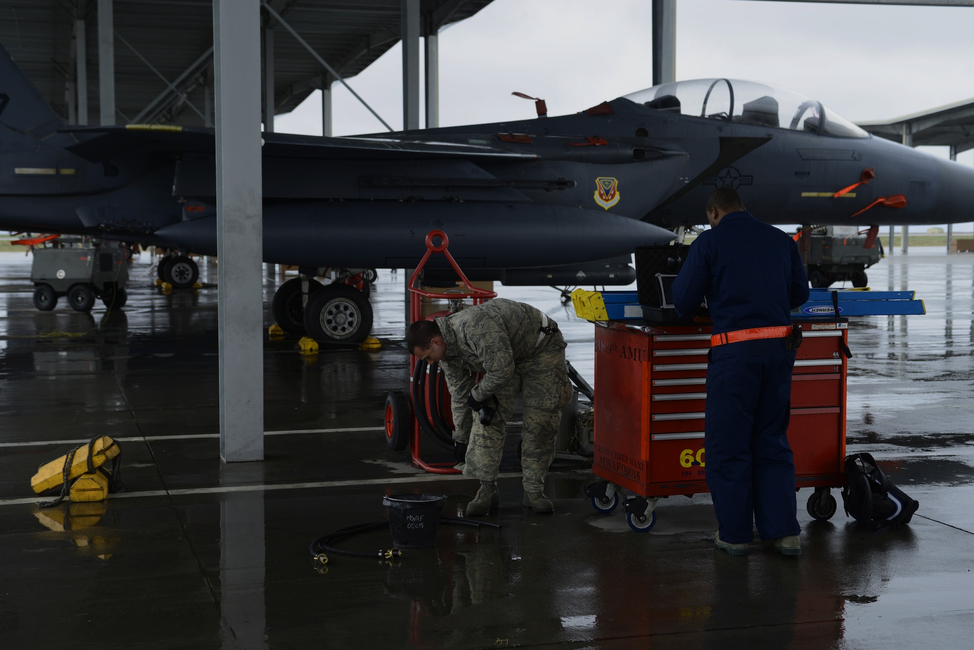 From left, Senior Airman Ben Failer, 366th Aircraft Maintenance Squadron aircraft armament systems technician, and Staff Sgt. Michael Gates, 366th AMXS crew chief, prepare for an aircraft to arrive March 10, 2014, at Mountain Home Air Force Base, Idaho. Members of the 389th Aircraft Maintenance Unit are currently participating in the Gunfighter Flag exercise. Operations out of MHAFB will be increased throughout the week of March 10-14. Gunfighter Flag is an excellent opportunity for ground crew members to train and respond to multiple daily launches. (U.S. Air Force photo by Senior Airman Ben Sutton/Released)


