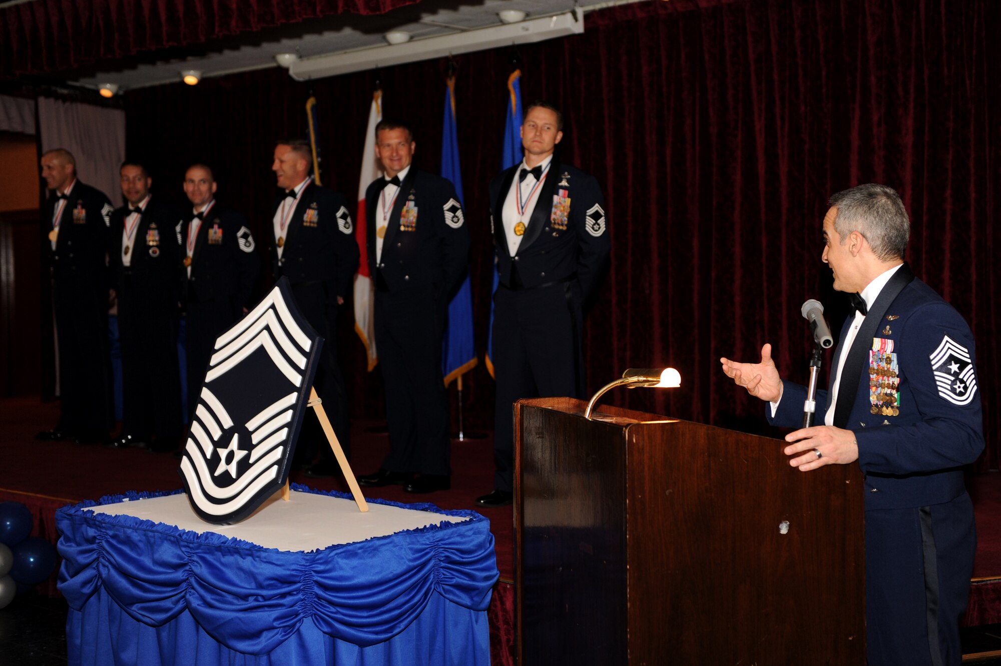 U.S. Air Force Chief Master Sgt. Ramon Colon-Lopez, 18th Wing command chief, speaks to the newly promoted chief master sergeants at the Chief Recognition Ceremony at the Rocker NCO Club on Kadena Air Base, Japan, March 6, 2014. Enlisted service members placed corresponding chevrons on a chief master sergeant rank insignia and lit candles representing their enlisted rank. (U.S. Air Force photo by Airman 1st Class Hailey R. Staker)