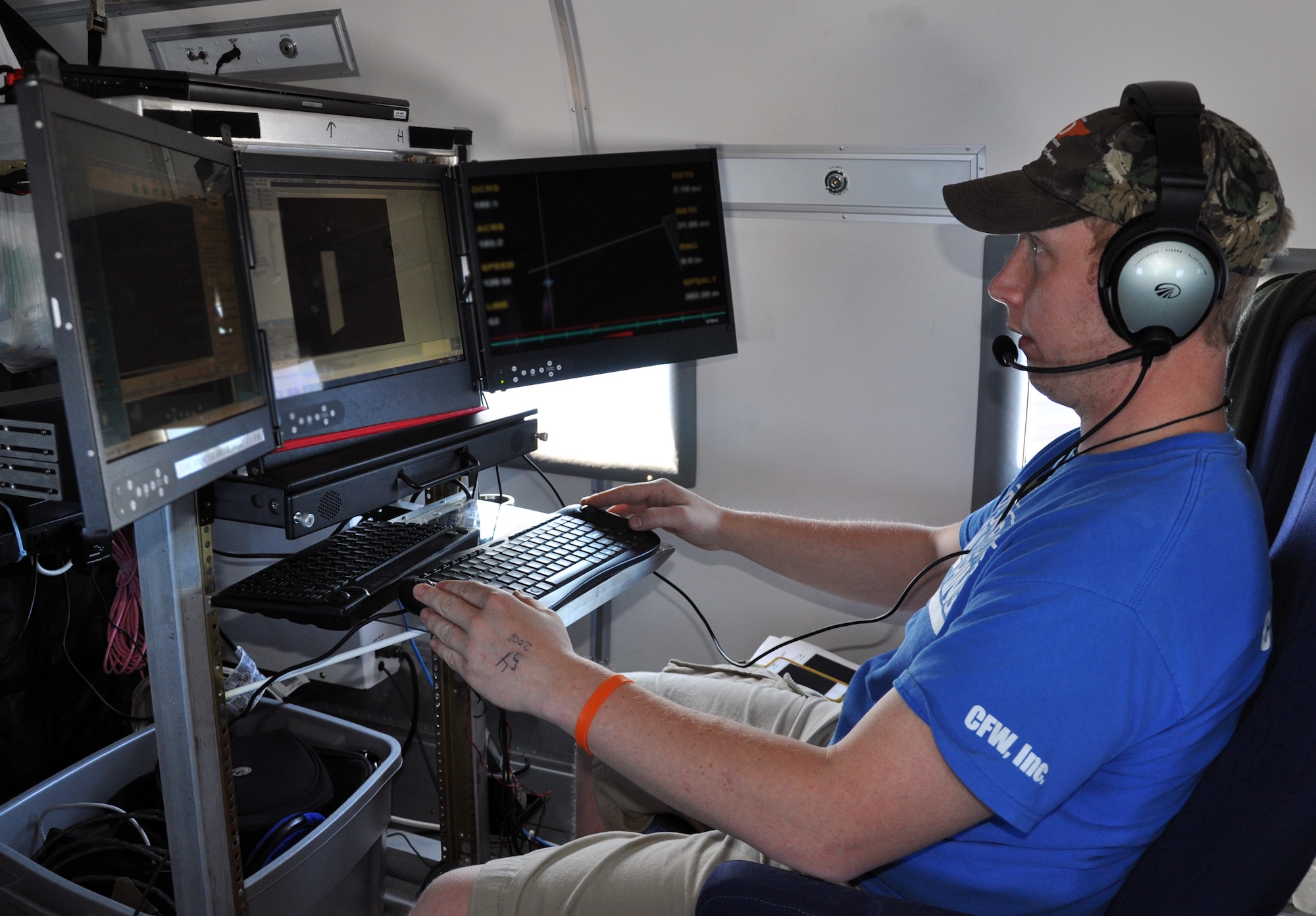 Zach Mahr, an airborne sensor operator, checks data readings while flying in a Bassler BT-67 aircraft over the Caribbean Ocean off the coast of Honduras during a airborne coast survey, Feb. 28, 2014.  The airborne coast survey operation uses laser technology to provide a three dimensional map of the ocean floor.  (U.S. Air Force photo by Capt. Zach Anderson)
