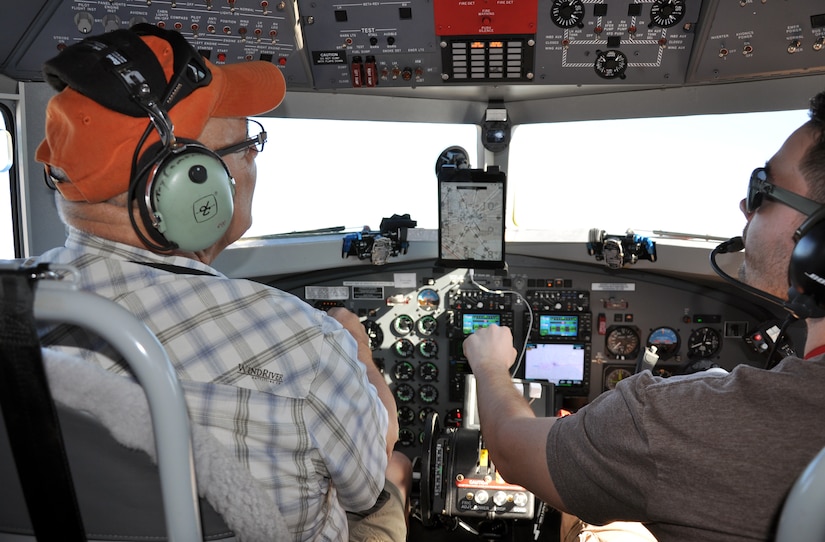 Pilot Ray Cameron and co-pilot Brody Epersen fly a Bassler BT-67 aircraft over the Caribbean Ocean off the coast of Honduras during a airborne coast survey, Feb. 28, 2014.  The airborne coast survey operation uses laser technology to provide a three dimensional map of the ocean floor.  (U.S. Air Force photo by Capt. Zach Anderson) 