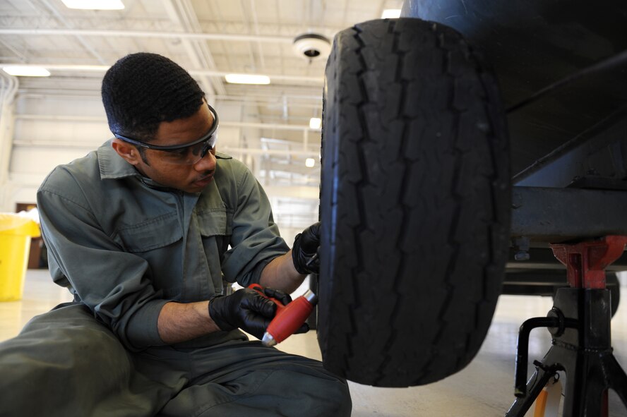 Airman 1st Class Udoka Addy, 22nd Maintenance Squadron aerospace ground equipment apprentice, checks and cleans the wheel bearings of a 600-gallon fuel bowser March 10, 2014, at McConnell Air Force Base, Kan. Airmen from AGE check these tankers every 180 days to ensure proper functionality and replace its grease. (U.S. Air Force photo/Airman 1st Class David Bernal Del Agua)