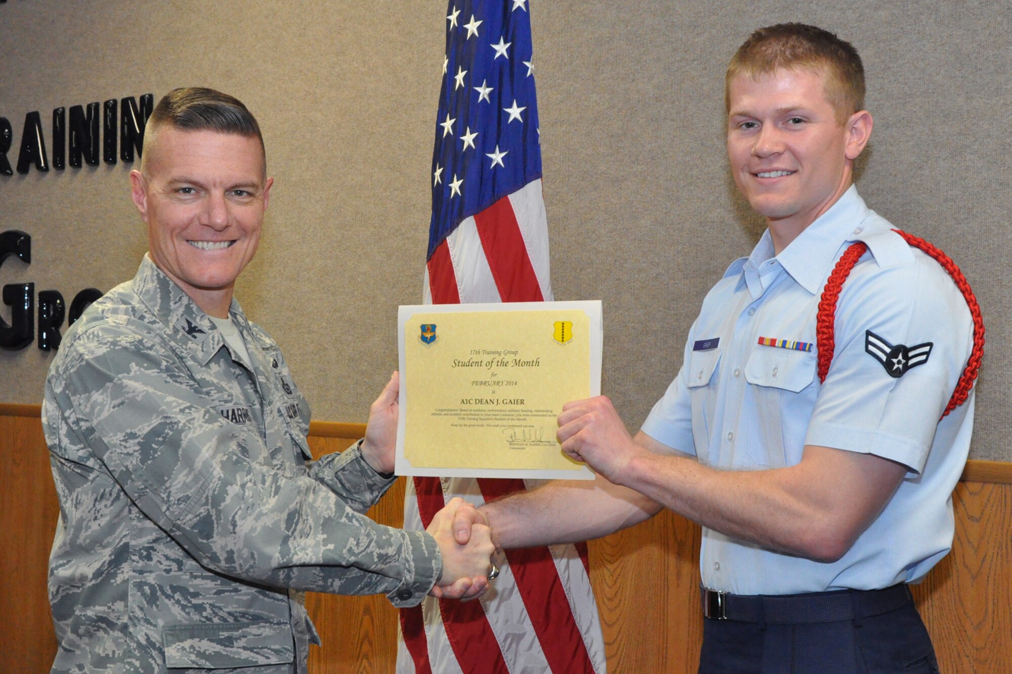 GOODFELLOW AIR FORCE BASE, Texas -- Col. Brendan Harris, 17th Training Group Commander, presents the 315th Training Squadron Enlisted Student of the Month award for February 2014 to Airman 1st Class Dean Gaier, March 7. (U.S. Air Force photo/ Airman 1st Class Breonna Veal)
