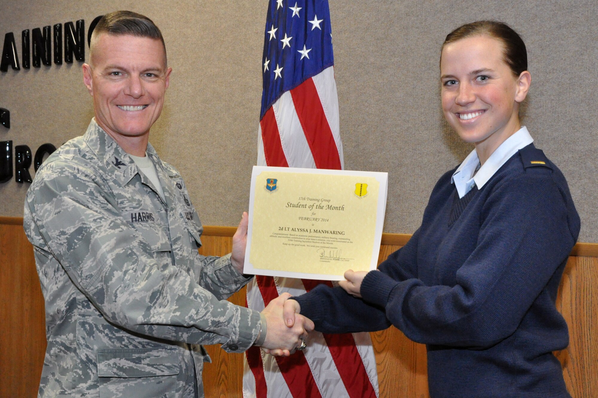 GOODFELLOW AIR FORCE BASE, Texas -- Col. Brendan Harris, 17th Training Group Commander, presents the 315th Training Squadron Officer Student of the Month award for February 2014 to 2nd Lt. Alyssa Manwaring, March 7. (U.S. Air Force photo/ Airman 1st Class Breonna Veal)