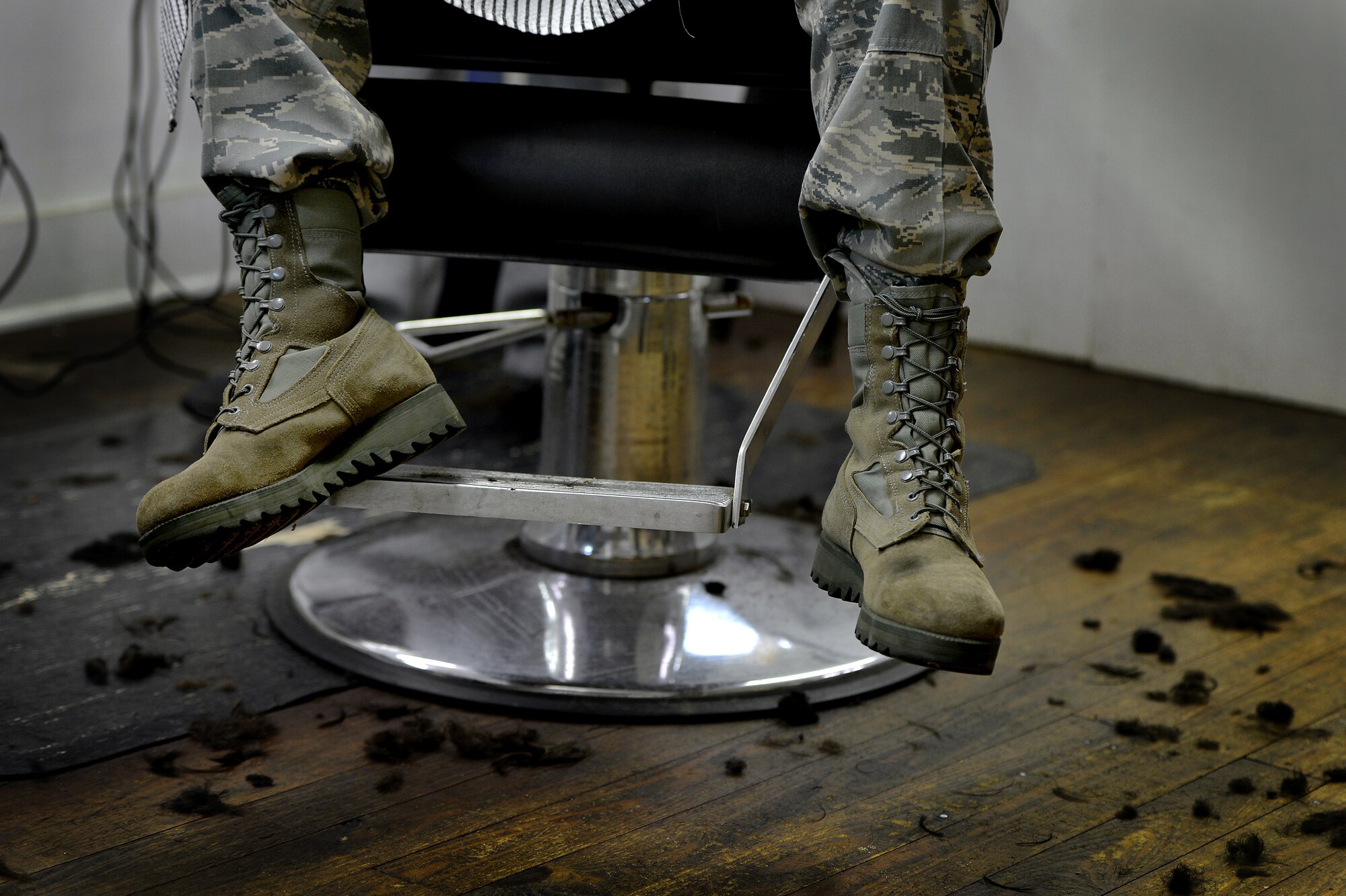 Hair collects on the floor of a local barber shop as 13 Airmen assigned to the 20th Logistics Readiness Squadron have their heads completely shaved in support of a 20th LRS wingman who was recently diagnosed with cancer, March 5, 2014, Sumter, S.C. The Airmen assigned to the 20th LRS pulled together and had their heads shaved to support their wingman who is now undergoing chemotherapy. The team of Airmen expressed a “one team, one fight” mind set and plan to help their wingman as he fights cancer. (U.S. Air Force photo by Staff Sgt. Kenny Holston/Released)