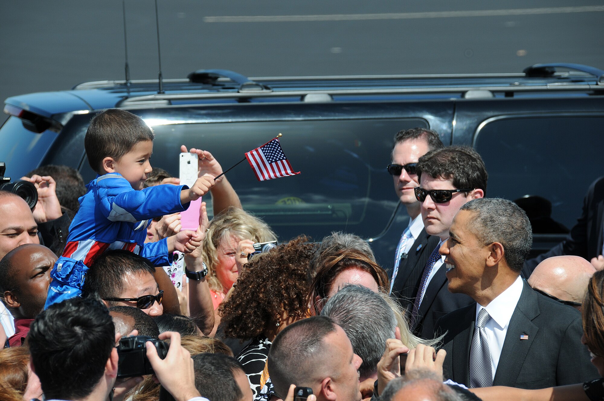 President Obama greets the crowd at Homestead Air Reserve Base Fla., on March 7.  The Obama’s made a brief stop at Homestead ARB prior to departing for Coral Reef High School in Miami, Fla. (U.S. Air Force photo/Tim Norton)