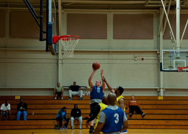 Justin Bellamy 628th Civil Engineer Squadron Team 2, takes a shot during an intramural basketball game March 4, 2014, at the Joint Base Charleston – Air Base Fitness Center. The 628th CES Team 1 beat the 628th CES Team 2, 50-36. (U.S. Air Force photo/Staff Sgt. William O’Brien)