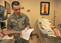 Airman 1st Class Nathaniel Beiter, 319th Medical Support Squadron medical lab technician, confirms the patient information on a prescription pill container during a Patient Safety Room of Horrors challenge on March 6, 2014, at the women’s health clinic on Grand Forks Air Force Base, N.D. Beiter participated in the challenge to find 34 potential or actual patient safety hazards, which is part of a series of activities put on by the 319th MDG in observance of this year’s National Patient Safety Week. (U.S. Air Force photo/Senior Airman Xavier Navarro)