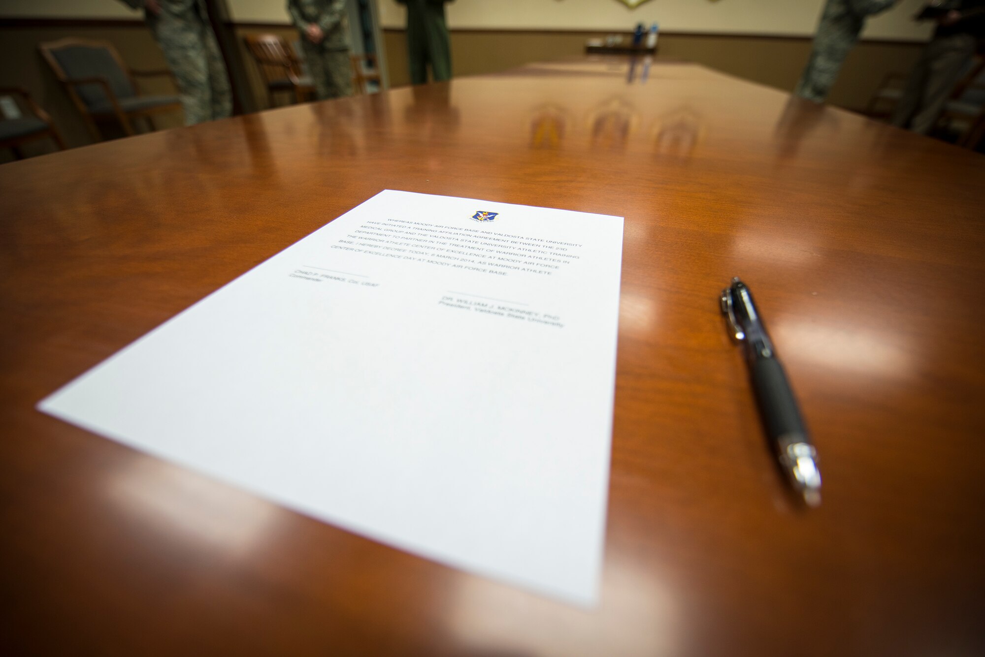 A proclamation sits at the head of the table before a signing ceremony at Moody Air Force Base, Ga., March 6, 2014. Once it was signed, the proclamation established Warrior Athlete Center of Excellence Day, celebrating a new working relationship between Valdosta State University and the installation. (U.S. Air Force photo by Airman 1st Class Ryan Callaghan/Released)
