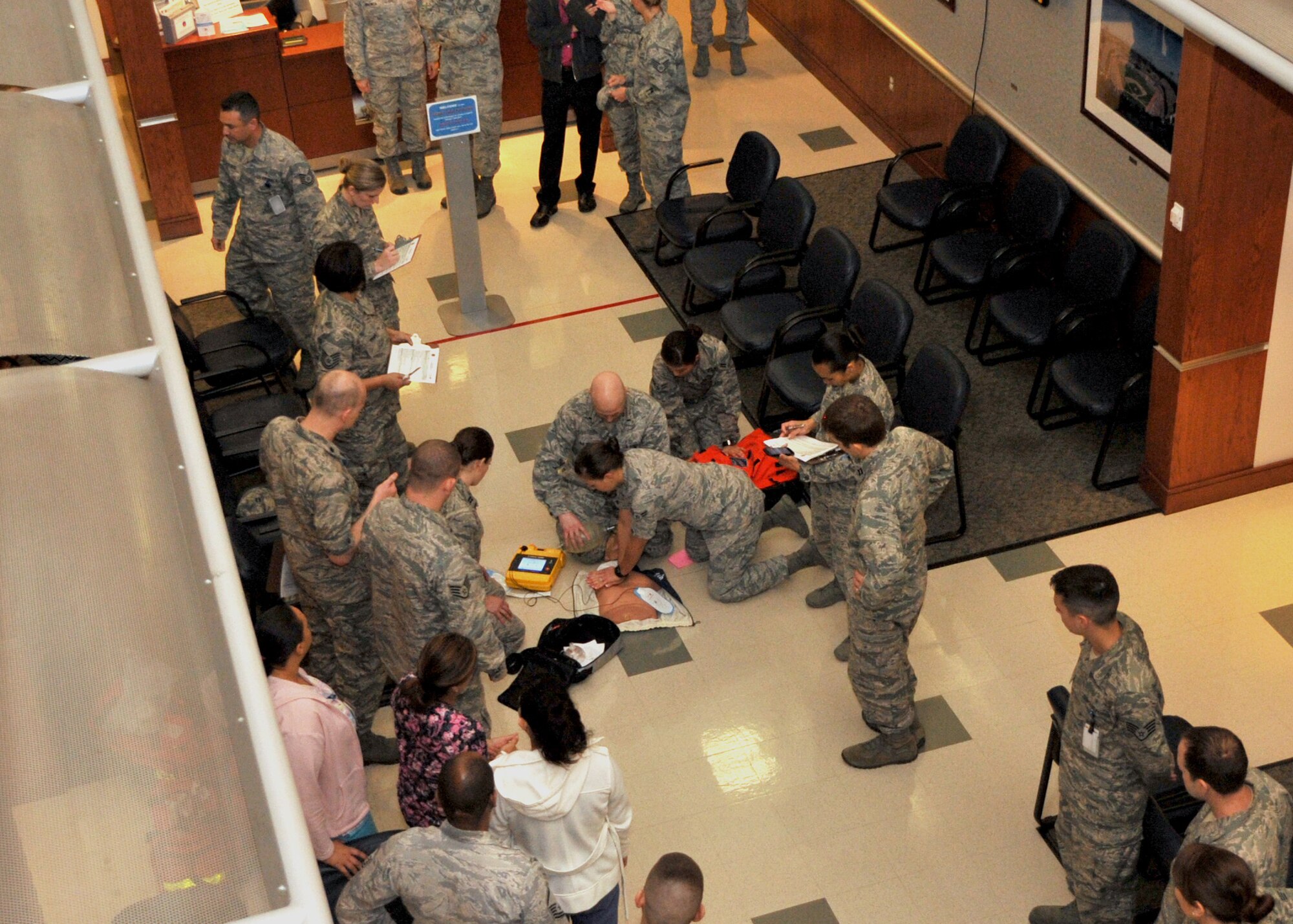 Medical personnel from the 61st Medical Squadron react to a Mock Code Blue exercise at Los Angeles Air Force Base in El Segundo, Calif., on March 6, 2014. Mock Code Blue exercises are held each quarter to ensure everyone in the medical squadron is prepared to respond to a cardiac arrest. (U.S. Air Force photo by Sarah Corrice).