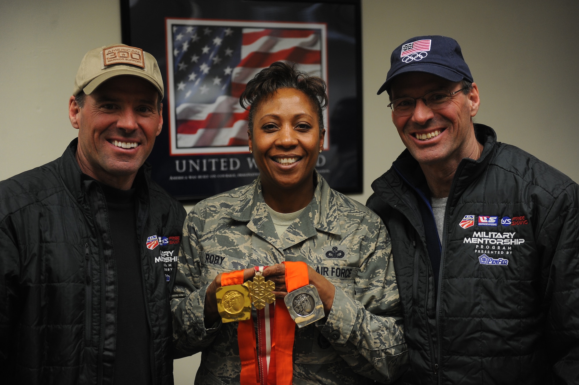 The American 300 tour visited Minot Air Force Base Airmen led by founder Robi Powers, and three special guests.  Olympic medalists Phil and Steve Mahre, and X Games medalist Erin Nemec, joined Powers in sharing their stories of failure and triumph through their careers, and the importance of teamwork and camaraderie.  Passing their medals from Airman to Airman, the Olympians made a point to share their victories with the service men and women of the United States, stating that a win for an American Olympian, is a win for America. (U.S. Air Force photos/Airman 1st Class Lauren Pitts)