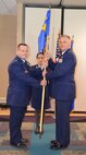 Lt. Col. Jason Exum, right, assumes command of the 26th Aerial Port Squadron from Col. Craig Peterson, left, at a change of command ceremony here Mar. 9. (U.S. Air Force photo by 1st. Lt. Denise Haeussler)