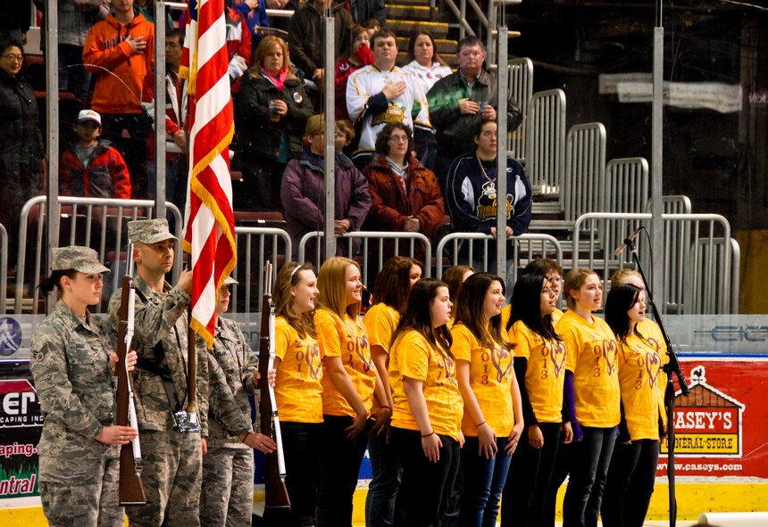 The 182nd Airlift Wing Color Guard presents the American flag during the singing of “The Star-Spangled Banner” at Carver Arena in Peoria, Ill., March 1, 2014. Trainees with the 182nd Airlift Wing Student Flight recited the armed forces oath of enlistment at from U.S. Air Force Col. William P. Robertson, commander of the 182nd Airlift Wing, on the ice as part of the Peoria Rivermen hockey team’s Air National Guard night. Student flight is an initiative to prepare new enlistees for military service before leaving for basic military training. (U.S. Air National Guard photo by Staff Sgt. Lealan Buehrer/Released)