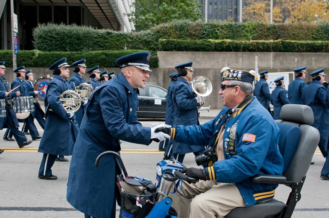 2LT Justin W. Lewis shakes hands a veteran attending the Pittsburgh, PA Veteran's Day Parade November 11, 2013.