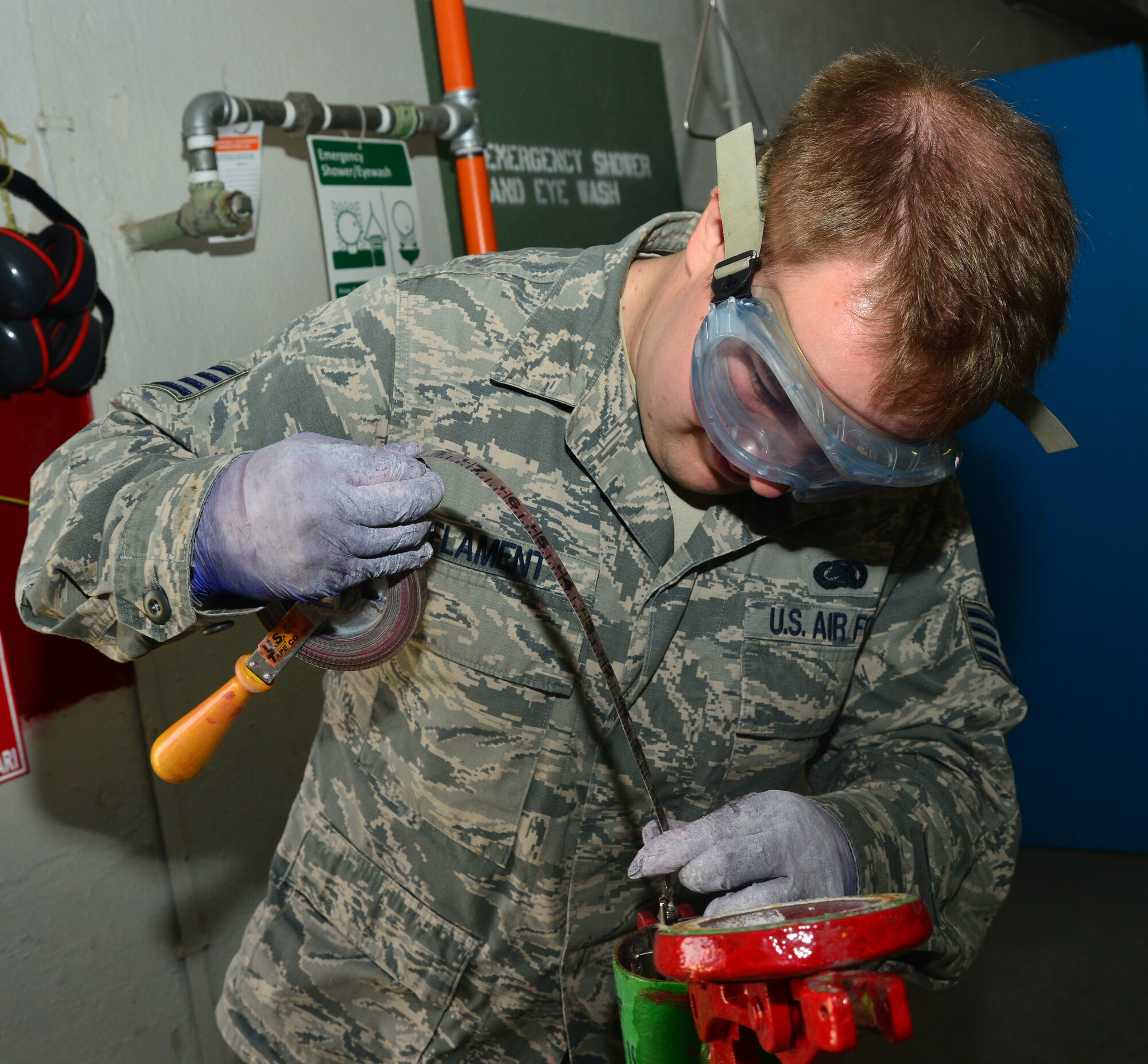 Staff Sgt. Luke Flament, 39th Logistics Readiness Squadron petroleum, oil and lubricants flight, inserts a dipstick to measure fluid levels March 6, 2014, Incirlik Air Base, Turkey. The POL flight distributes hundreds of gallons of gasoline per month in support of NATO and U.S. missions. (U.S. Air Force photo by Staff Sgt. Eric Summers Jr./Released)
