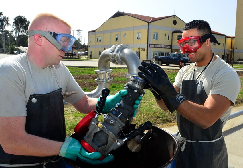 Senior Airman Gunnar Lange and Airman 1st Class Robert Acevedo, 39th Logistics Readiness Squadron petroleum, oil and lubricants flight, reinstall a strainer into a fuel tube after checking for contaminates March 6, 2014, Incirlik Air Base, Turkey. The POL flight distributes hundreds of gallons of gasoline per month in support of NATO and U.S. missions. (U.S. Air Force photo by Staff Sgt. Eric Summers Jr./Released)