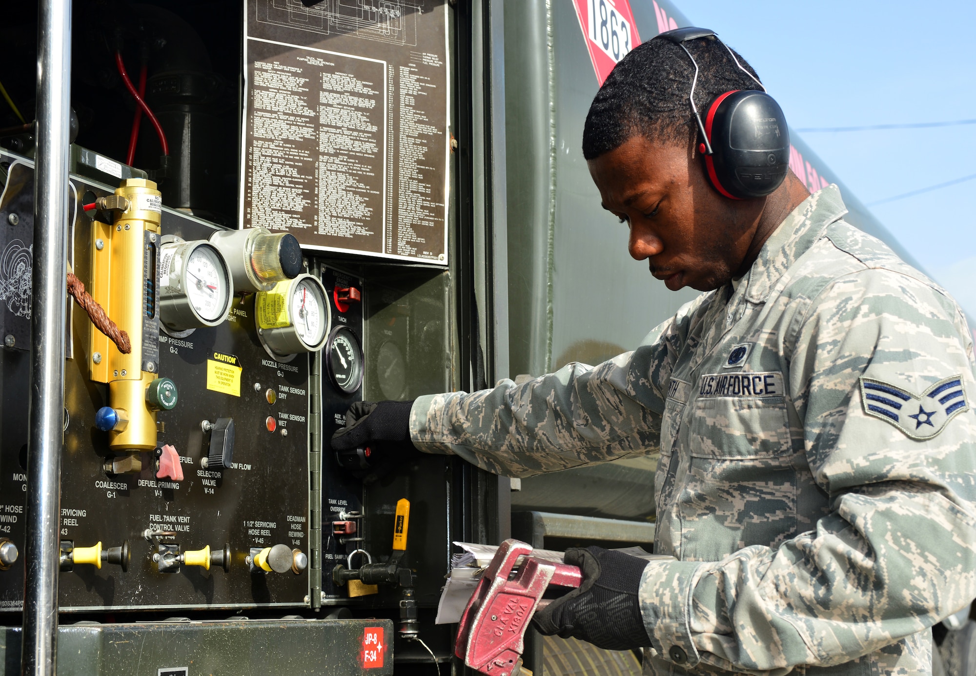 Senior Airman Justin Smith, 39th Logistics Readiness Squadron petroleum, oil and lubricants flight, compares gauge readings to technical orders while refueling March 6, 2014, Incirlik Air Base, Turkey. The Airmen of POL ensure mission readiness at all times by maintaining their own equipment and providing clean fuel by sampling and testing. (U.S. Air Force photo by Staff Sgt. Eric Summers Jr./Released)