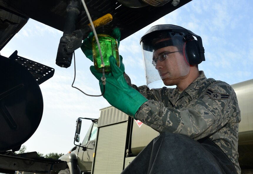 Airman 1st Class Andrew Peters, 39th Logistics Readiness Squadron petroleum, oil and lubricants flight, holds up a jar of jet fuel to scan for visible contaminates March 6, 2014, Incirlik Air Base, Turkey. The visible scan is one method to ensure that fuel delivered to aircraft is clean and ready for use. (U.S. Air Force photo by Staff Sgt. Eric Summers Jr./Released)