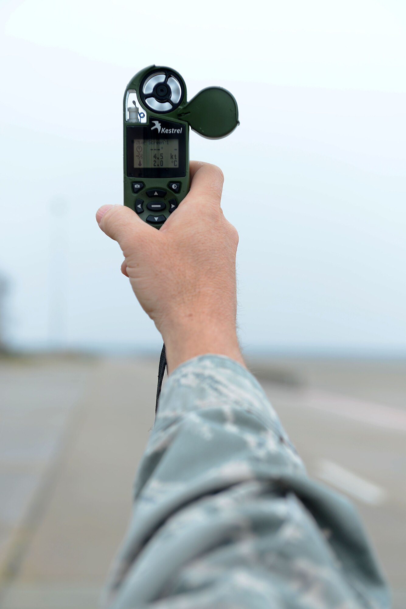 U.S. Air Force Tech. Sgt. Adam Salter, 20th Operations Support Squadron airfield elements NCO in charge, determines wind speed on the flightline at Shaw Air Force Base, S.C. March 5, 2014. Salter was using a pocket weather tracker, a device used track current weather conditions by determining temperature, dew point, pressure and wind chill. (U.S. Air Force photo by Airman 1st Class Jensen Stidham/Released)