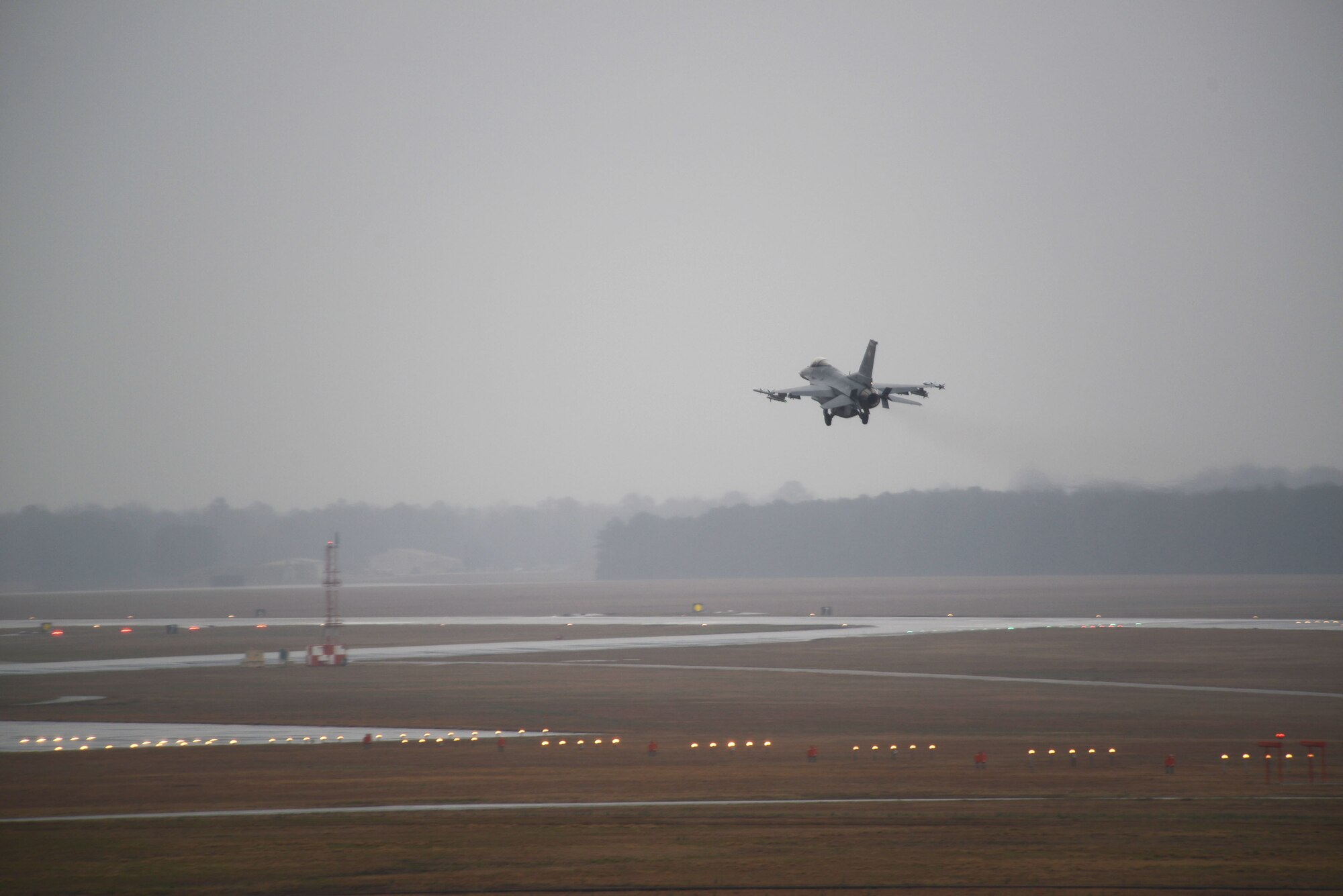 An F-16 Fighting Falcon descends for landing at Shaw Air Force Base, S.C. March 6, 2014. A group of 55th Fighter Squadron pilots flew a training mission during low visibility and rain during severe weather severe weather season which occurs from March through August. (U.S. Air Force photo by Airman 1st Class Jensen Stidham/Released)