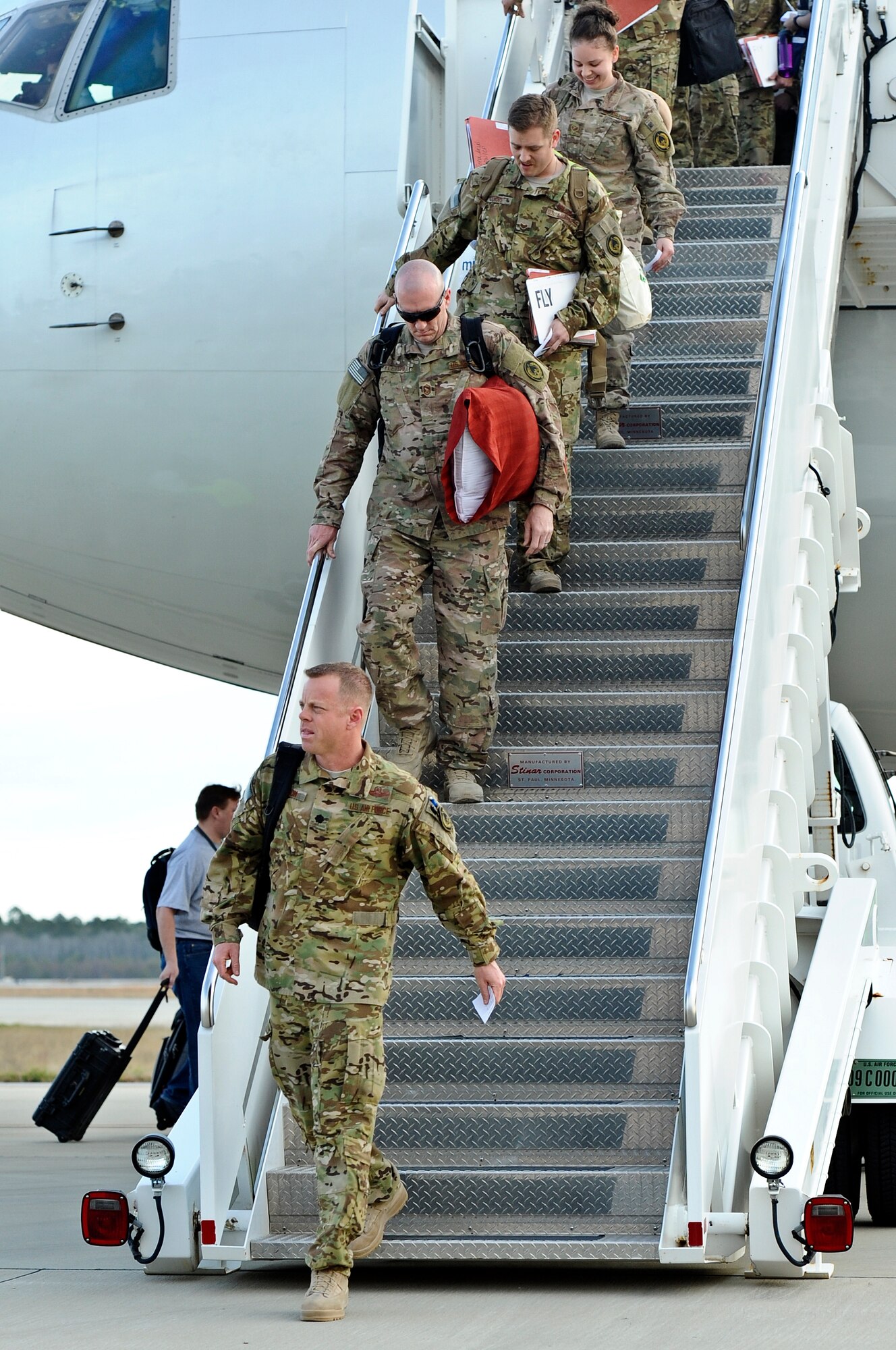 Family members, friends and fellow Air Commandos gather to welcome home more than 100 Hurlburt Airmen at the 9th Aircraft Maintenance Unit Hangar on Hurlburt Field, Fla., March 9, 2014. The Airmen in-processed through such functions as medical and finance on site. (U.S. Air Force photo/Senior Airman Michelle Patten)